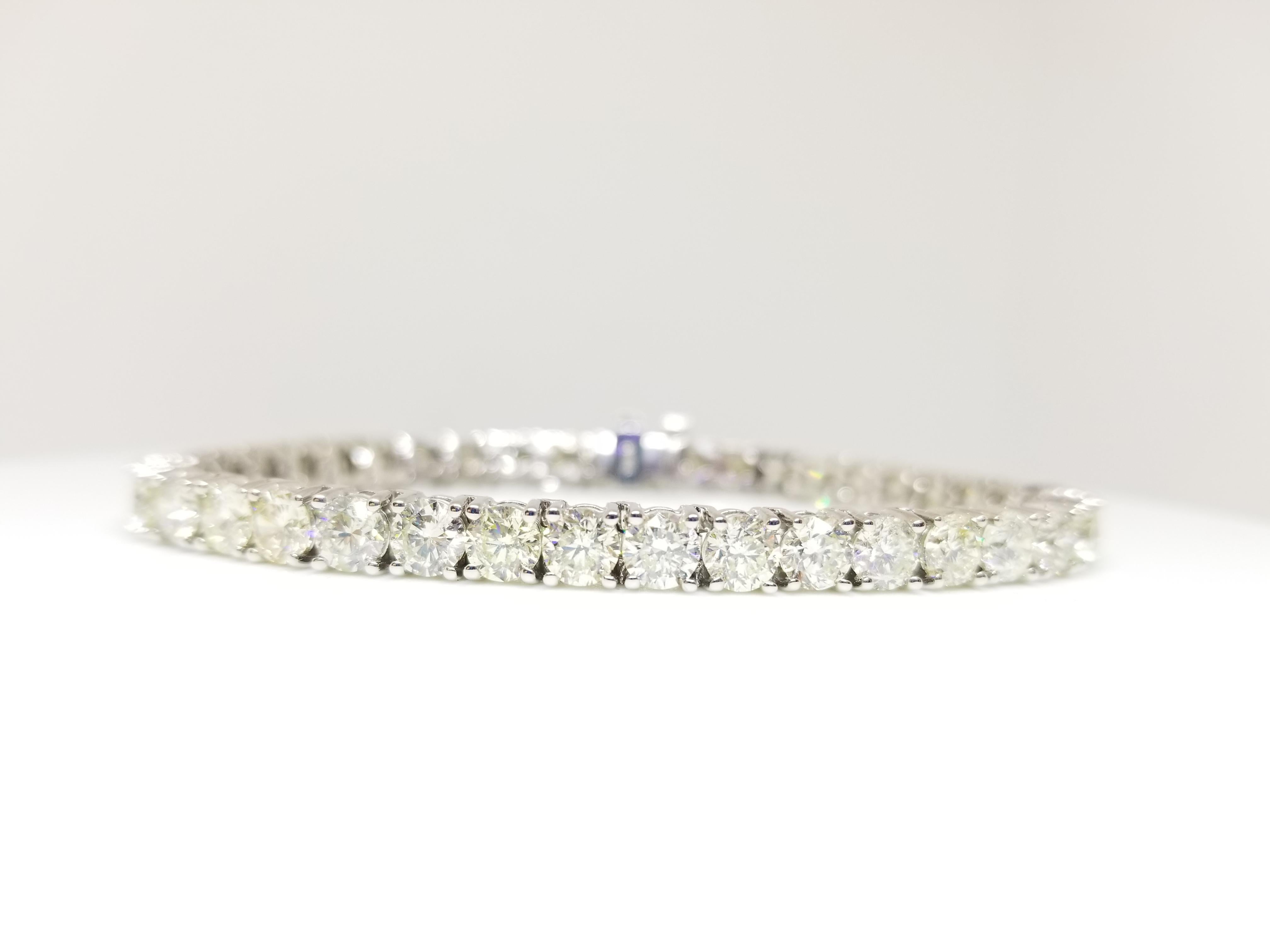 Great quality tennis bracelet, containing 40 pcs of round-brilliant cut white diamonds clean and Excellent shine, Average of 0.35 carats each Diamond . 14k white gold classic four-prong style for maximum light brilliance. 7 inch length. Color I-J,