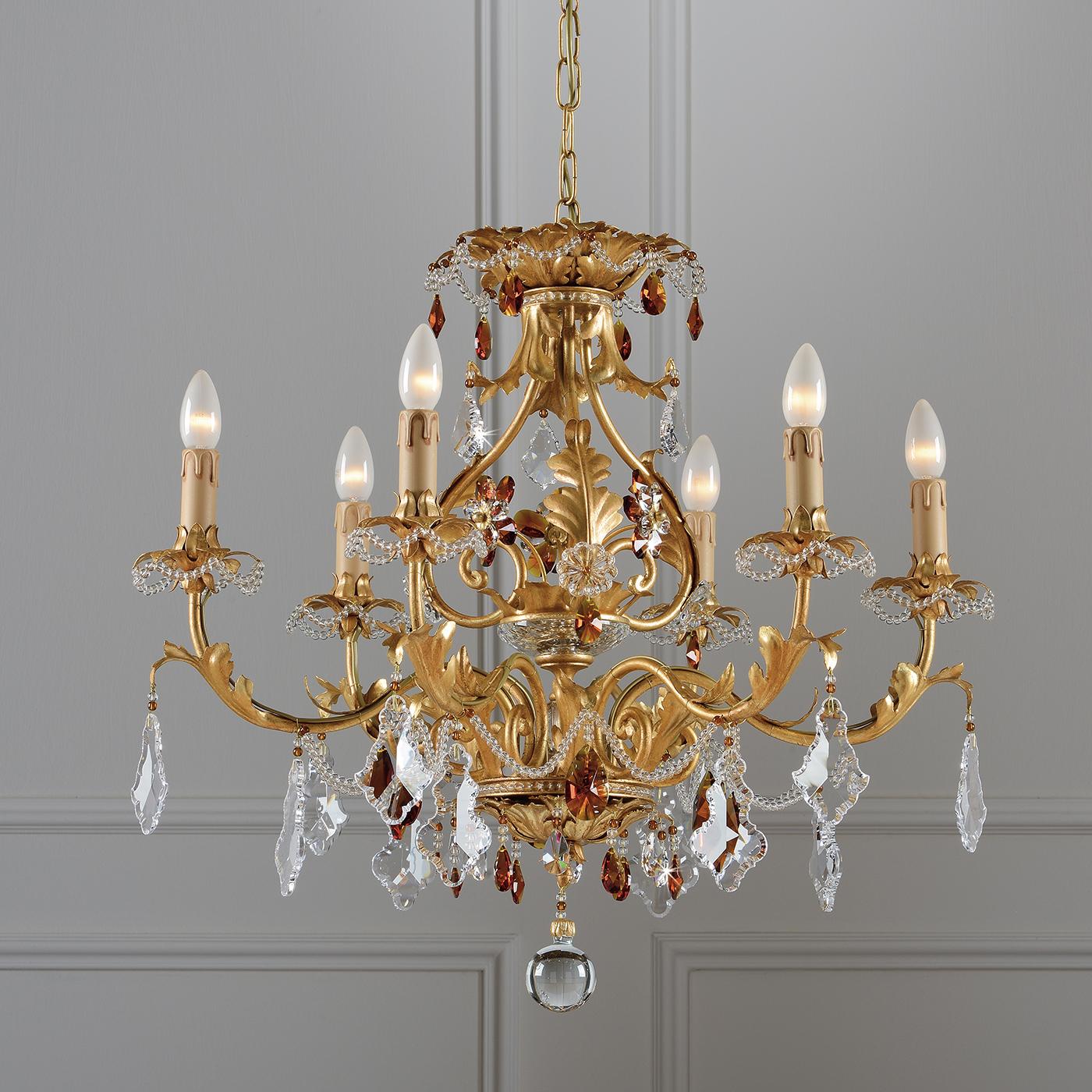 Pared down extravagance awaits in this charming six-arm chandelier. Inspired by traditional styles, the chandelier features an aged gold leaf coating, lending it antique charm. The chandelier is completed by transparent and amber crystals to reflect