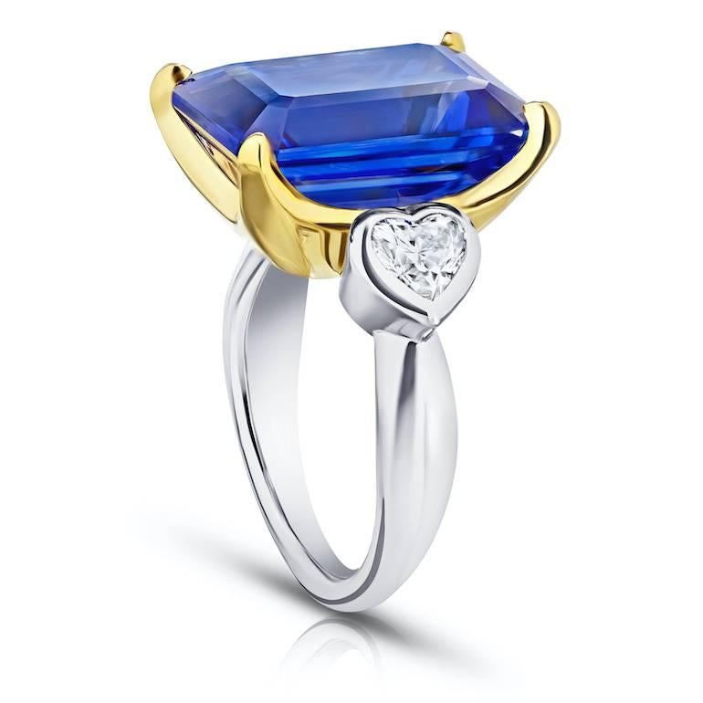 13.97 carat Blue Emerald Cut Tanzanite set with two Heart Shape diamonds .91 carats set in a Platinum and 18k yellow gold ring
