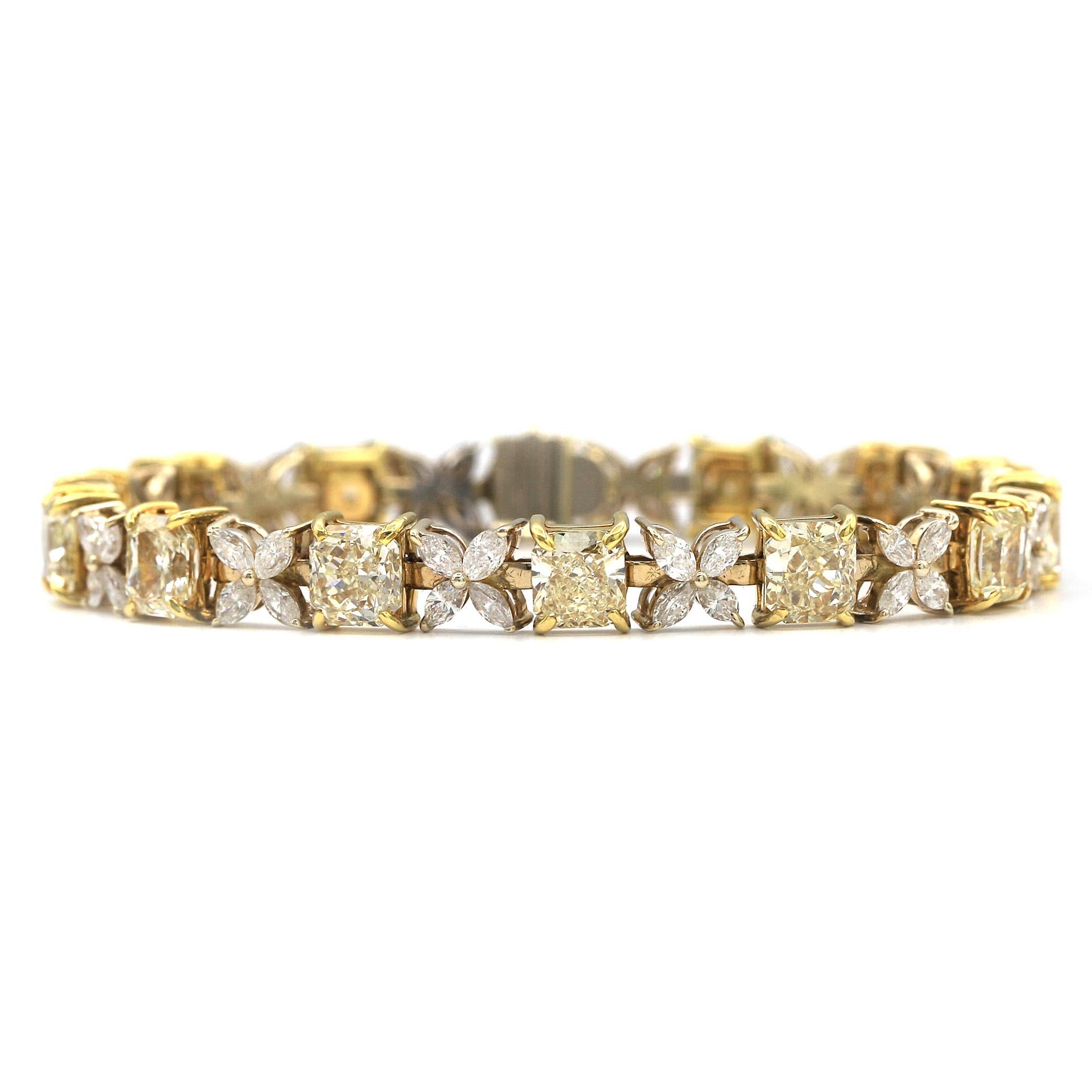 This beautiful floral shape bracelet features 14 Radiant shape Fancy Yellow Diamonds and 56 White Marquee shape diamonds giving it a total weight of 13.99 carats. It mounted in 18K Yellow Gold.
Length is 7 inches 