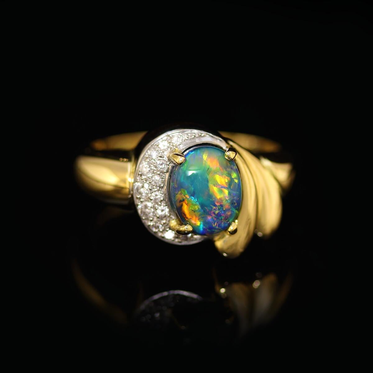 This classical elegant high jewellery grade diamond ring features a black opal with blues, greens, and oranges. Set in no less than 18K solid gold and platinum, it's a true heart-stopper.

All our rings are complimentarily resized to fit you