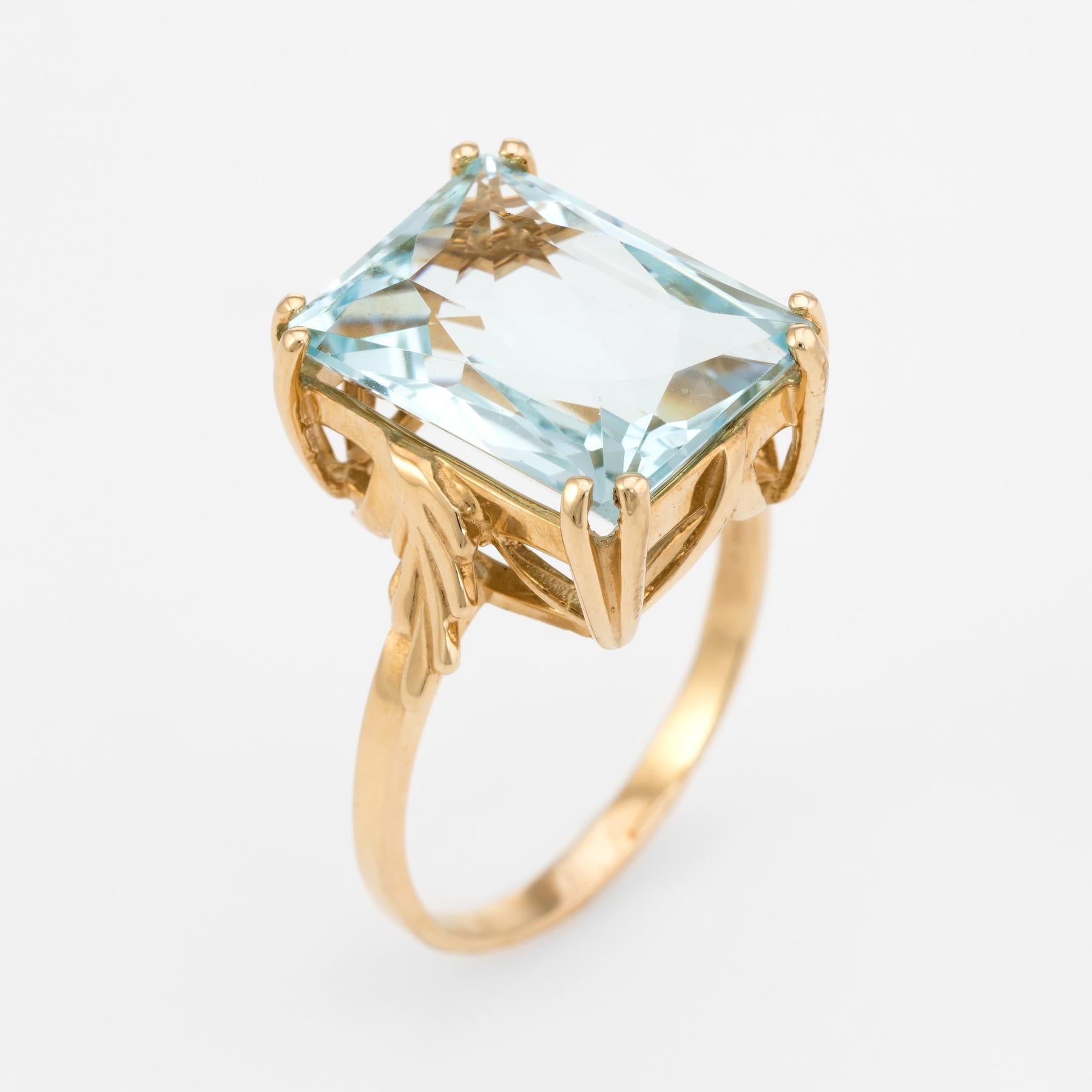 Elegant large aquamarine cocktail ring, crafted in 14 karat yellow gold. 

Faceted emerald cut aquamarine measures 16mm x 12mm (estimated at 13 carats). The aquamarine is in excellent condition and free of cracks or chips.   

The ring is in
