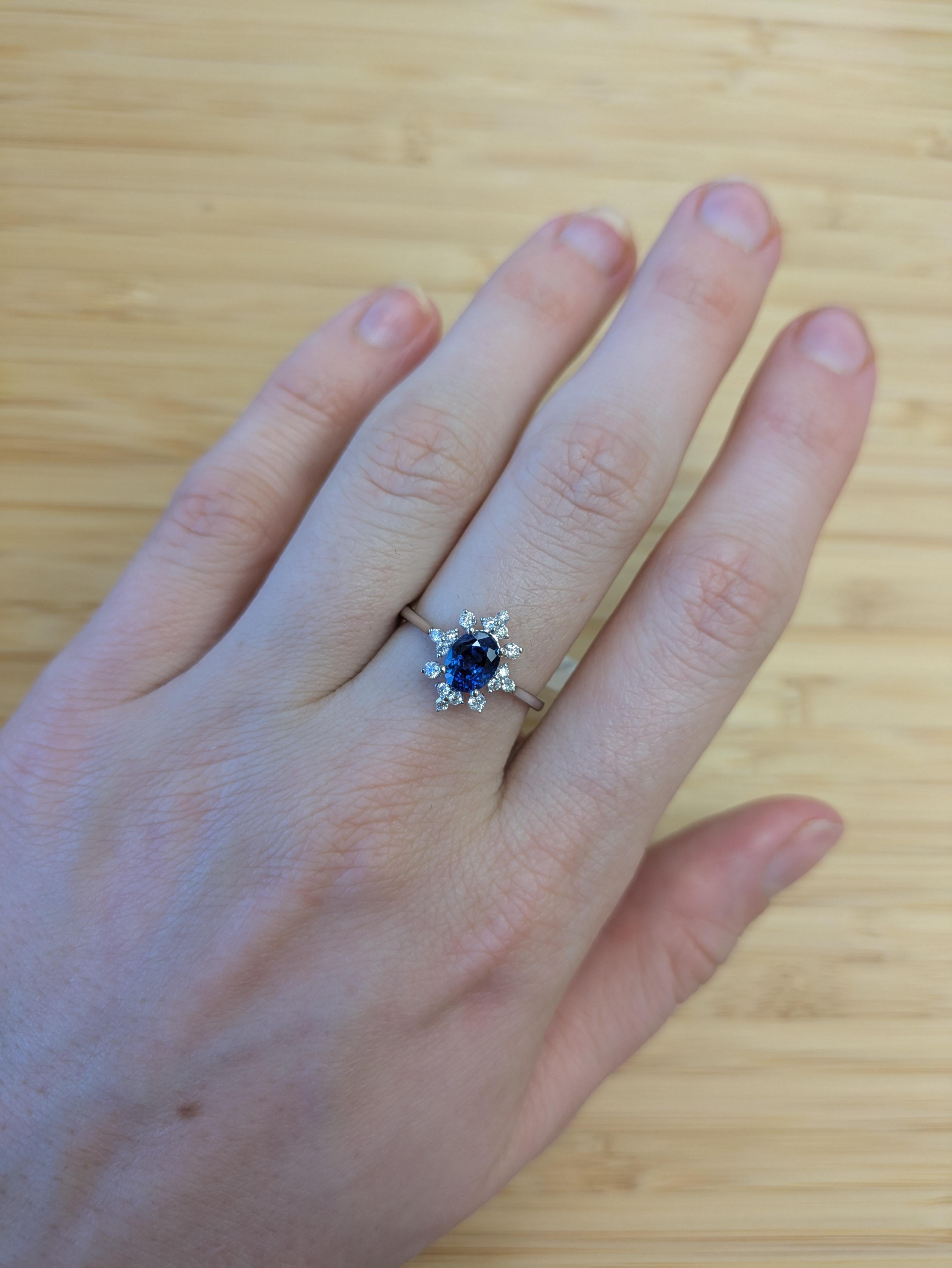 A breathtaking 1.29 carat Ceylon sapphire is the centerpiece of this classic engagement ring, framed by sparkling earth-mined diamond accents. Set in 14K solid gold, it’s a graceful blend of tradition and luxury.

**We offer complimentary resizing,