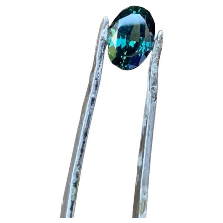  Step into a world of serene beauty with this EYE CLEAN 1.3-carat Oval Natural Unheated Teal Blue Sapphire Gemstone. Boasting an eye-clean clarity, this gemstone is a paragon of purity, with no visible inclusions to detract from its brilliance. The