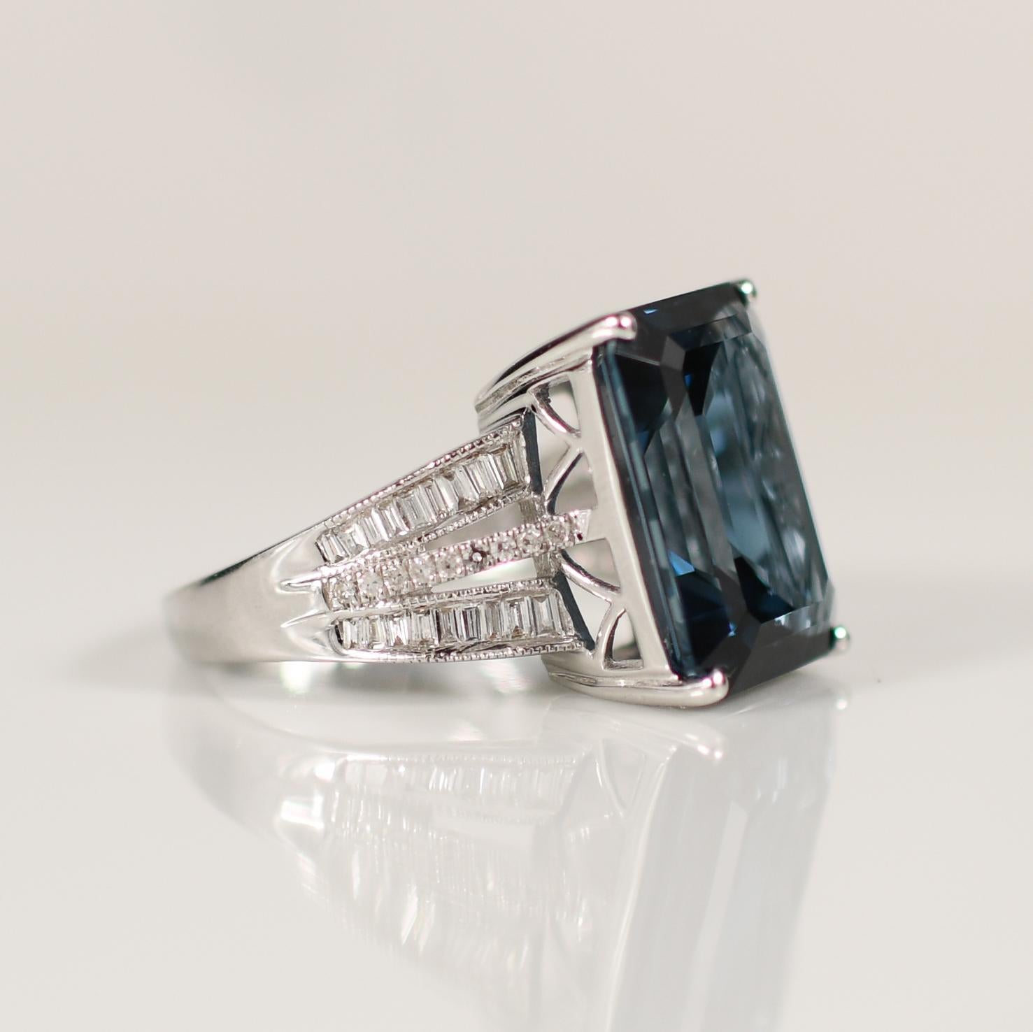 Dieser elegante Ring zeigt einen atemberaubenden 13-karätigen Londoner Blautopas, der sorgfältig in eine Smaragdform geschliffen wurde, die sein tiefes, fesselndes Blau hervorhebt. Der in 14 Karat Weißgold gefasste Ring wirkt schlicht und modern und