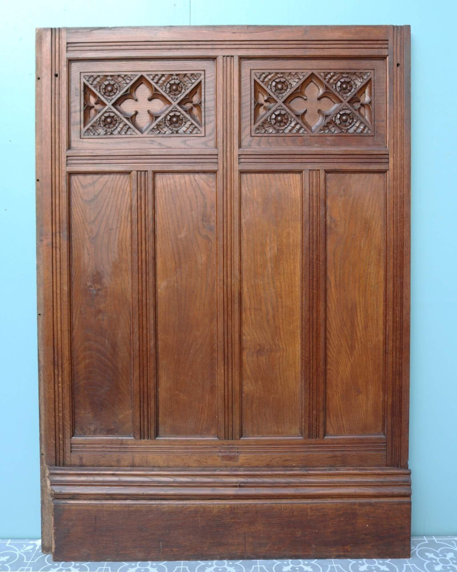 A decorative and ornate set of antique dado height carved oak wall paneling dating from the 1870s. Made from solid oak, these Victorian wall panels have a rich wood colour that looks beautiful in any period setting. Each one is detailed to the top