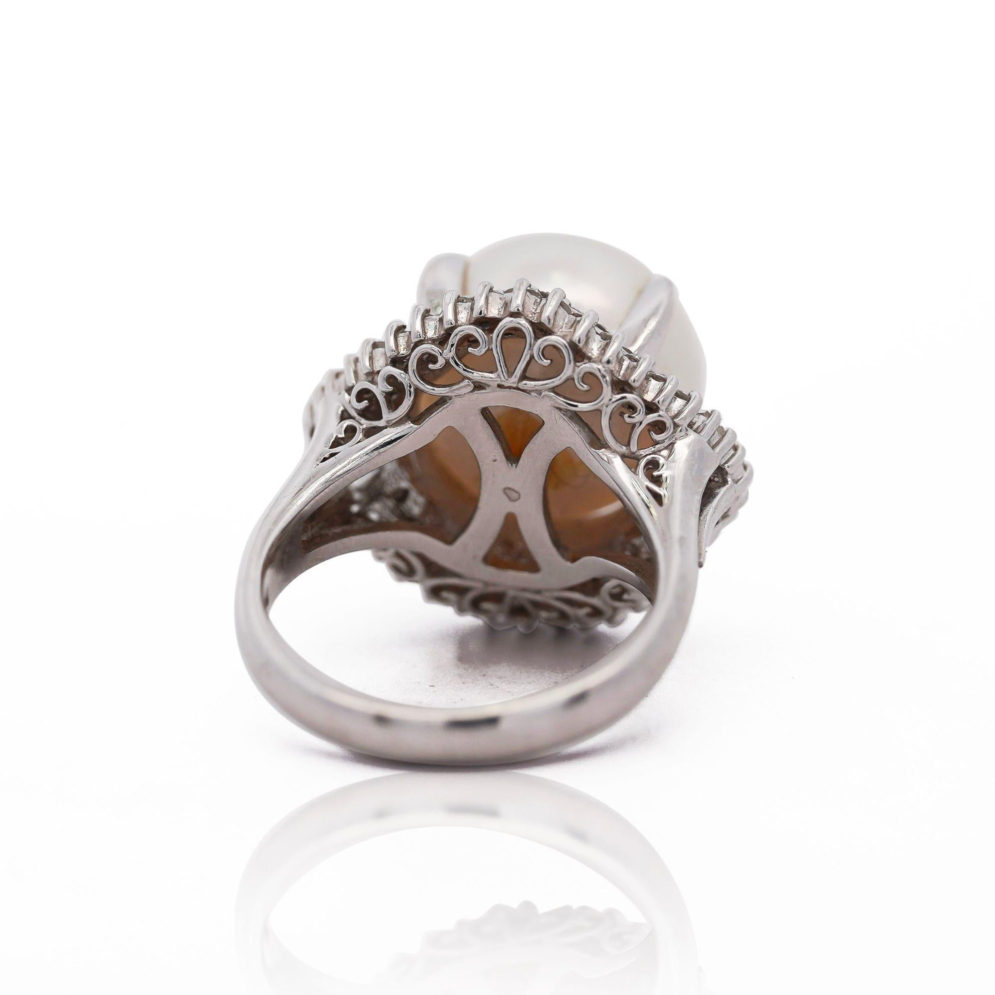 13mm Cultured South Sea Pearl and diamond ballerina ring. The Pearl bears excellent luster and uniformity, surrounded by 0.70 carats of baguette and round diamonds in platinum 900. 

Ring size 6, adjustable, weighing 14.71 grams total with intricate