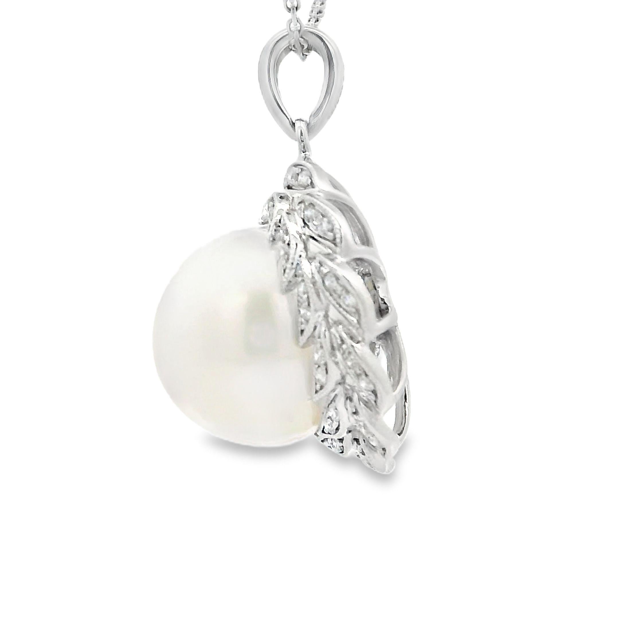 The 18K White Gold South Sea Pearl and Diamond Pendant is a stunning piece of jewelry that exudes sophistication and luxury. Its centerpiece is a beautiful 13 mm South Sea pearl, known for its lustrous glow and captivating charm.

The pearl is