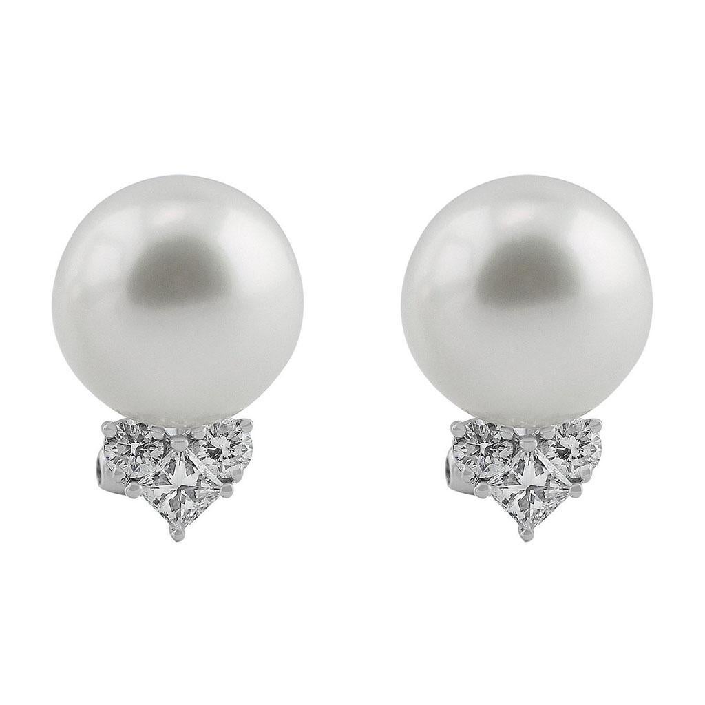 13mm South Sea pearl earrings with diamond accents set in 18k white gold with a clip back. There are 6 diamonds weighing a total of 0.81cttw.