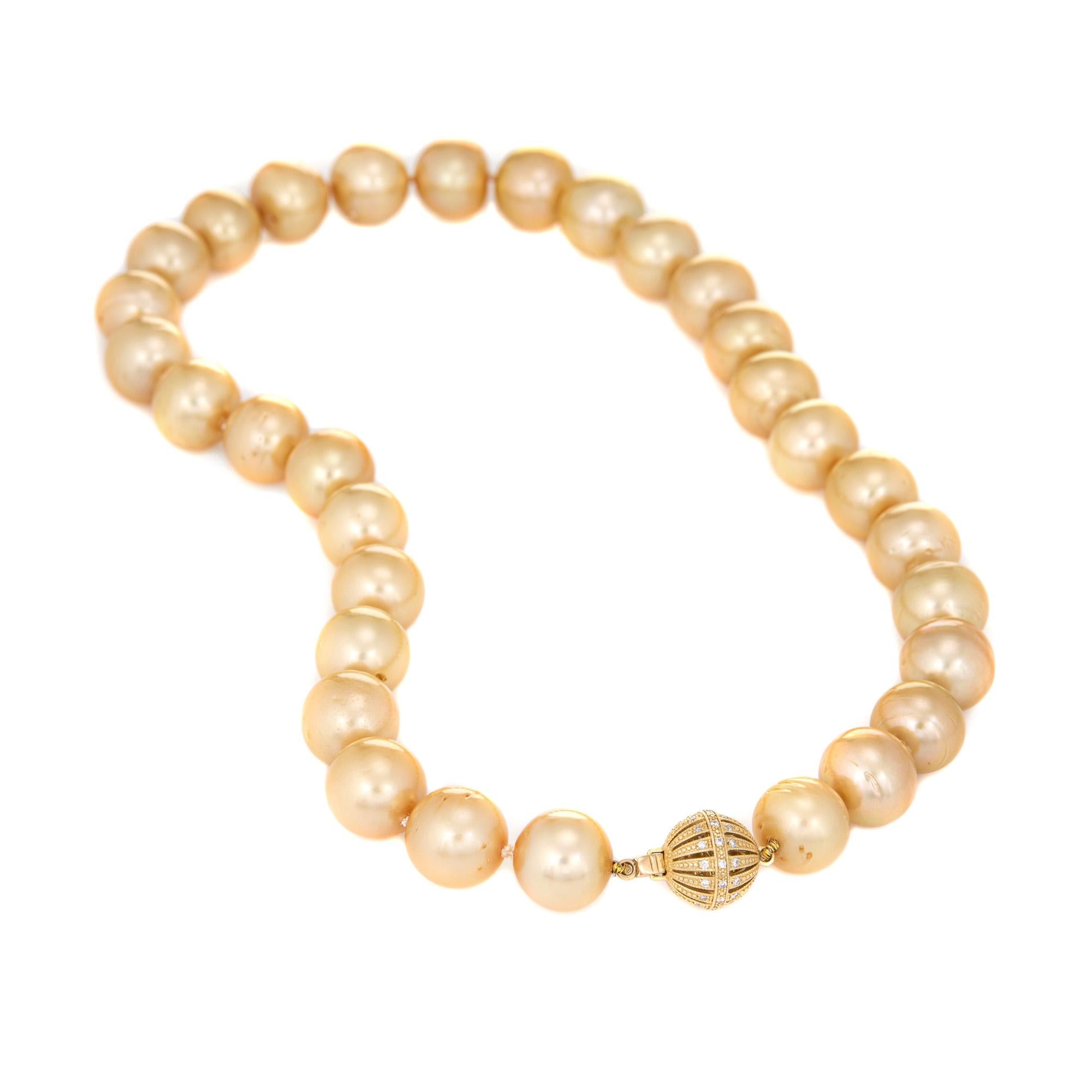 Stylish 13mm to 14mm Golden South Sea Pearl necklace finished with a 14k yellow gold clasp.   

Golden South Sea Pearls measure 13mm to 14mm. The pearls are slightly off-round with minor pits evident. The pearls exhibit excellent luster with a thick