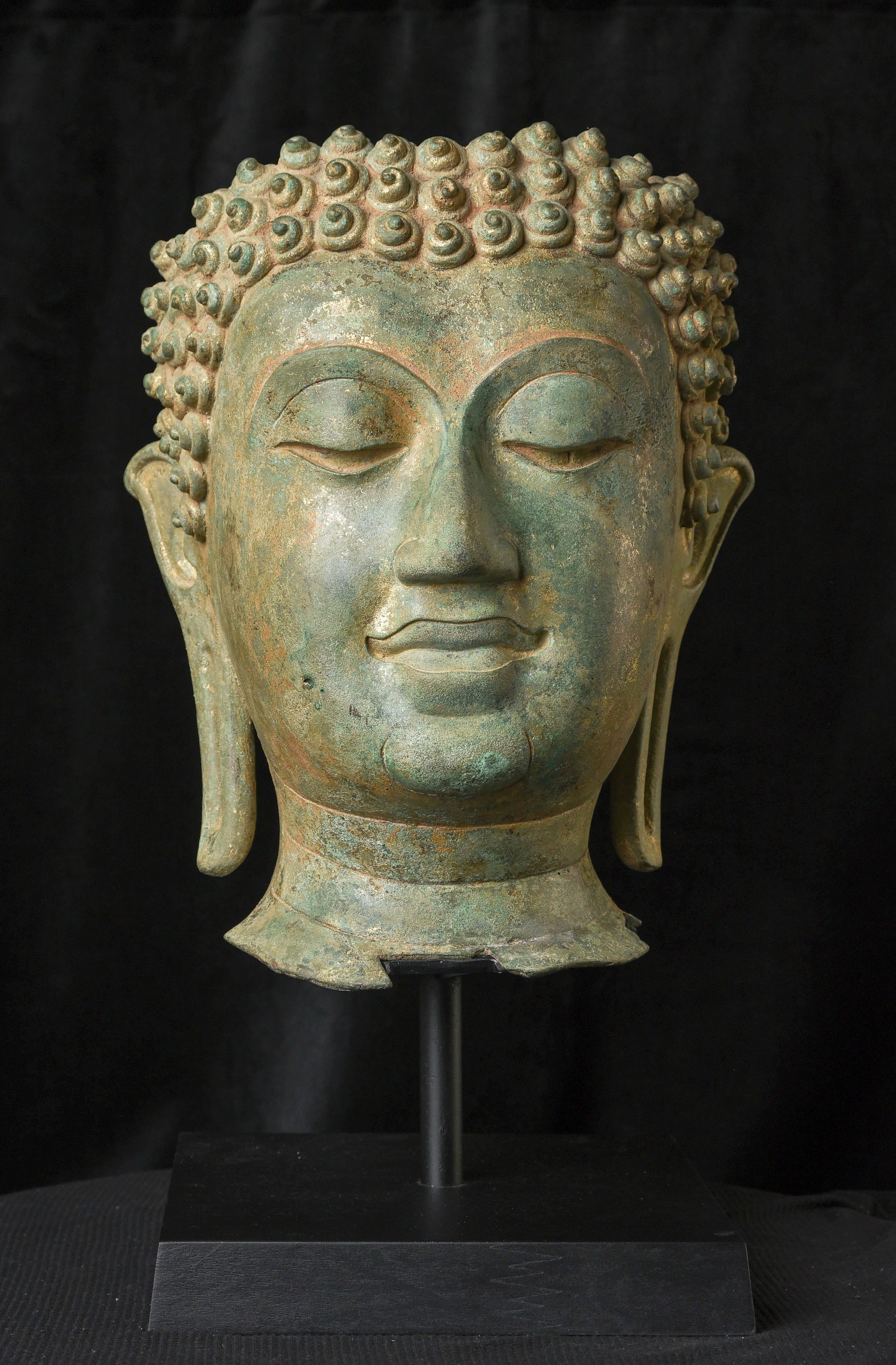 14th century Northern Sukhothai Walking Buddha Head-Museum quality. Near monumental- the full figure would have stood between 7 and 8 feet tall.
Very large bronze Buddhas, Especially those of high quality, had to be cast in many parts in order to