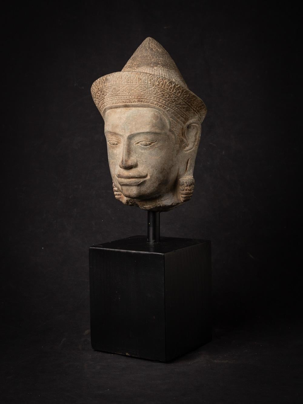 The 13th-century sandstone Vishnu head from the Bayon period is a remarkable and historically significant artifact originating from Cambodia. Crafted from sandstone, this Vishnu head stands at 47.5 cm in height, with the head alone measuring 27 cm