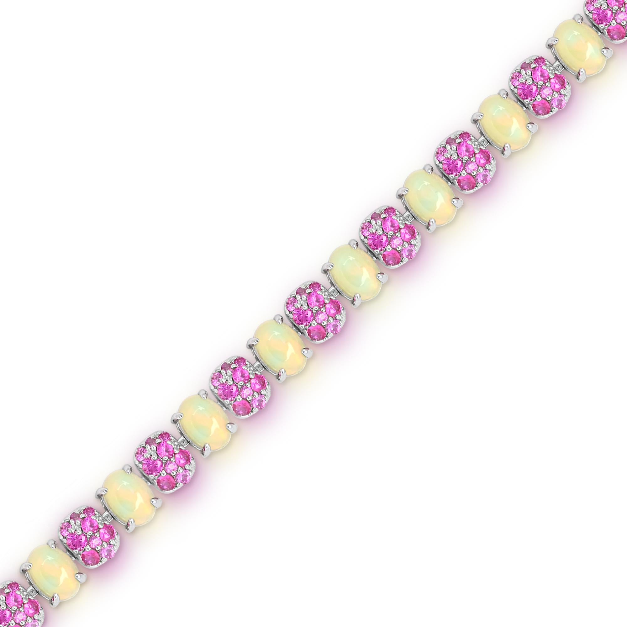 Indulge in the captivating beauty of our Sterling Silver Opal and Cluster Setting Pink Sapphire Bracelet. This exquisite piece features 15 oval-cut opal and 126 pieces of various sizes pink sapphire gemstones, delicately set in sterling silver. The