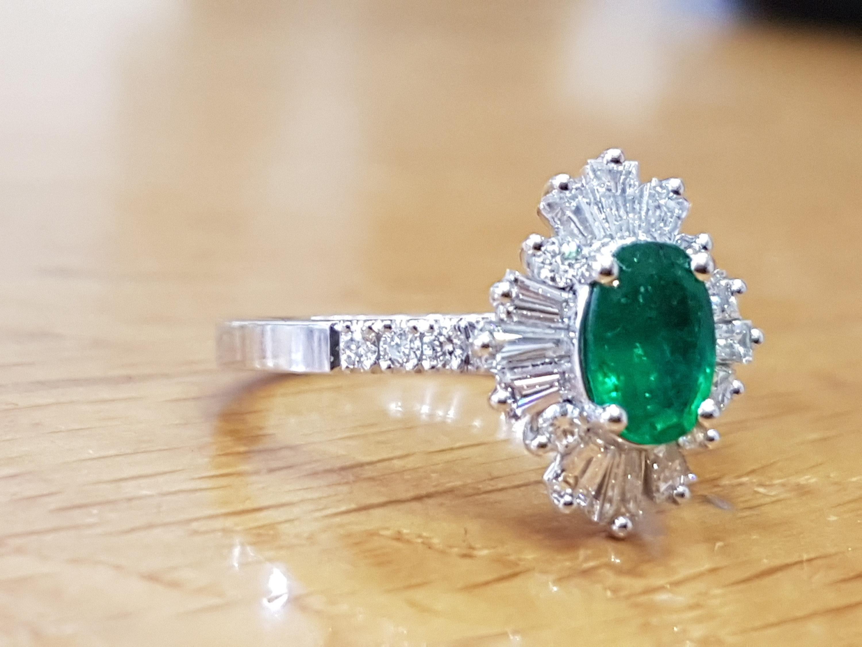 This beautiful Halo with accents vintage promise ring is made of 14k white gold with an oval-cut central Emerald which is accompanied by meticulously crafted melee round and baguette tapered cut diamonds . This high quality Halo pave style solitaire