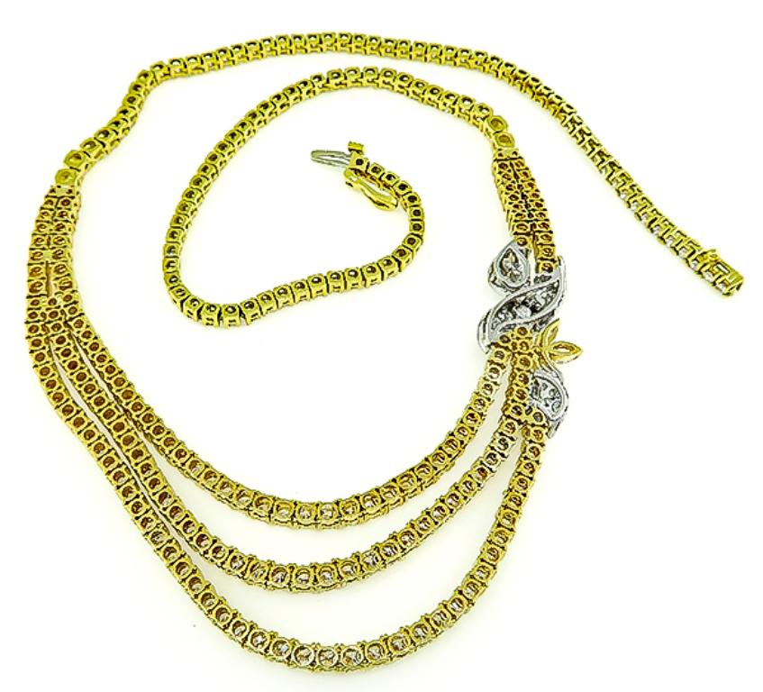 This gorgeous 18k yellow and white gold necklace is set with sparkling round and marquise cut diamonds that weigh approximately 14.00ct. graded G color with VS clarity. The necklace measures 17 1/2 inches in length and weighs 50.1 grams.
It is