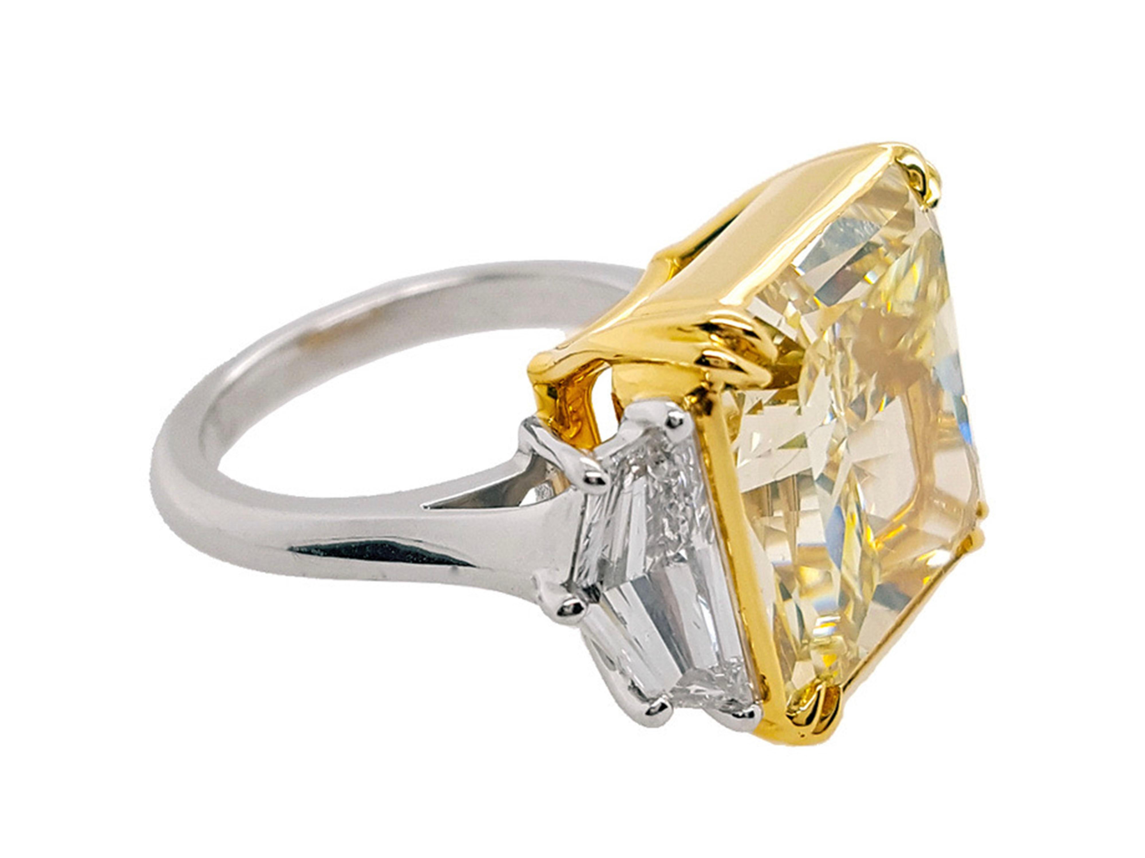 Absolutely stunning engagement ring style showcasing a Fancy Light Yellow 14 carat square cut diamond certified by GIA as VS1 clarity. The large size of the center stone turns this ring into a real showstopper. Flanked by two Cadillac cut diamonds