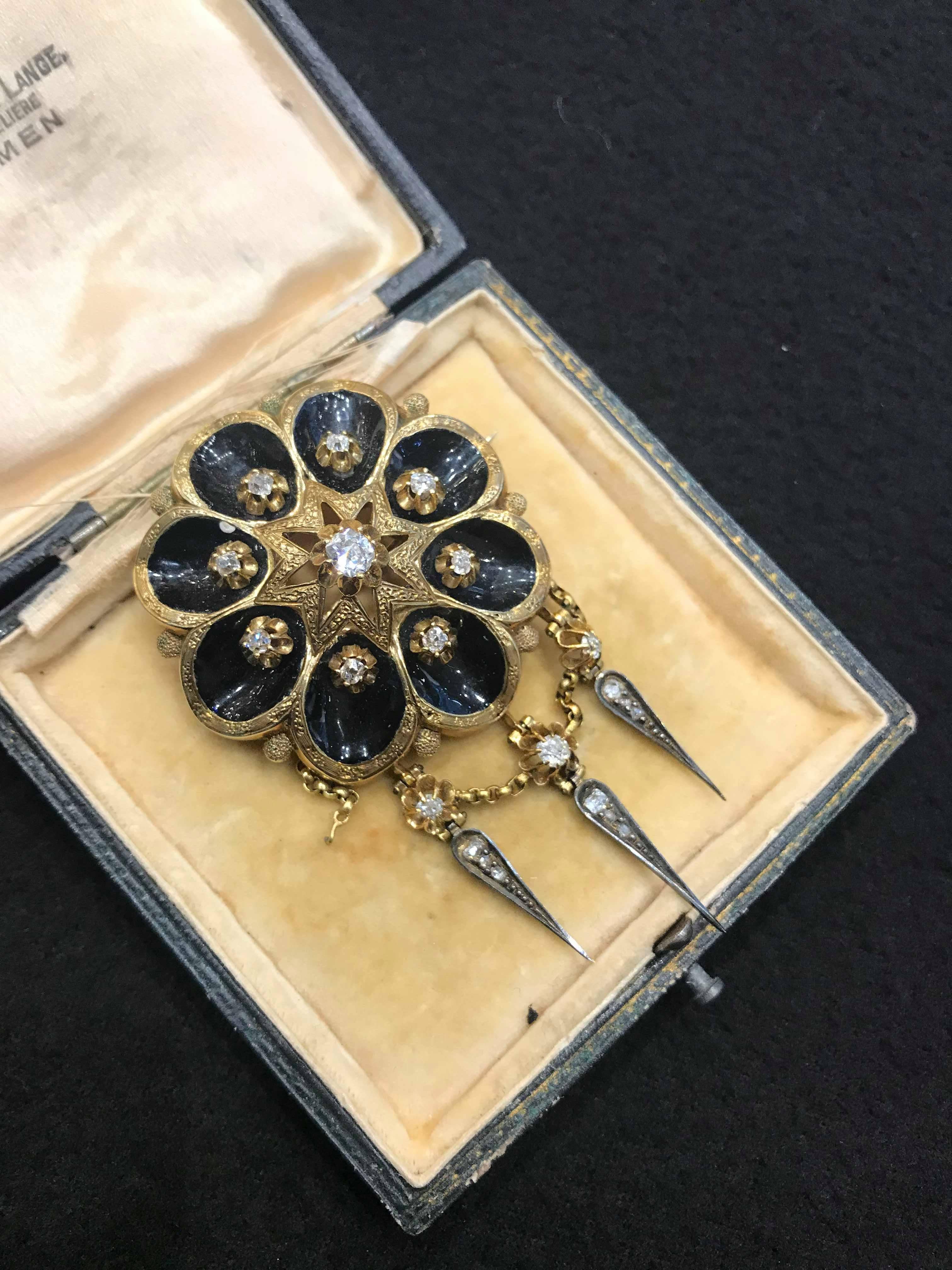 Dating back to the Victorian era of the 1860s and 1870s, this brooch is an elegant example of classic mourning jewellery. Crafted in 14 carat yellow gold with a central diamond of 0.40ct and a further eighteen diamonds equating to 1.02ct.