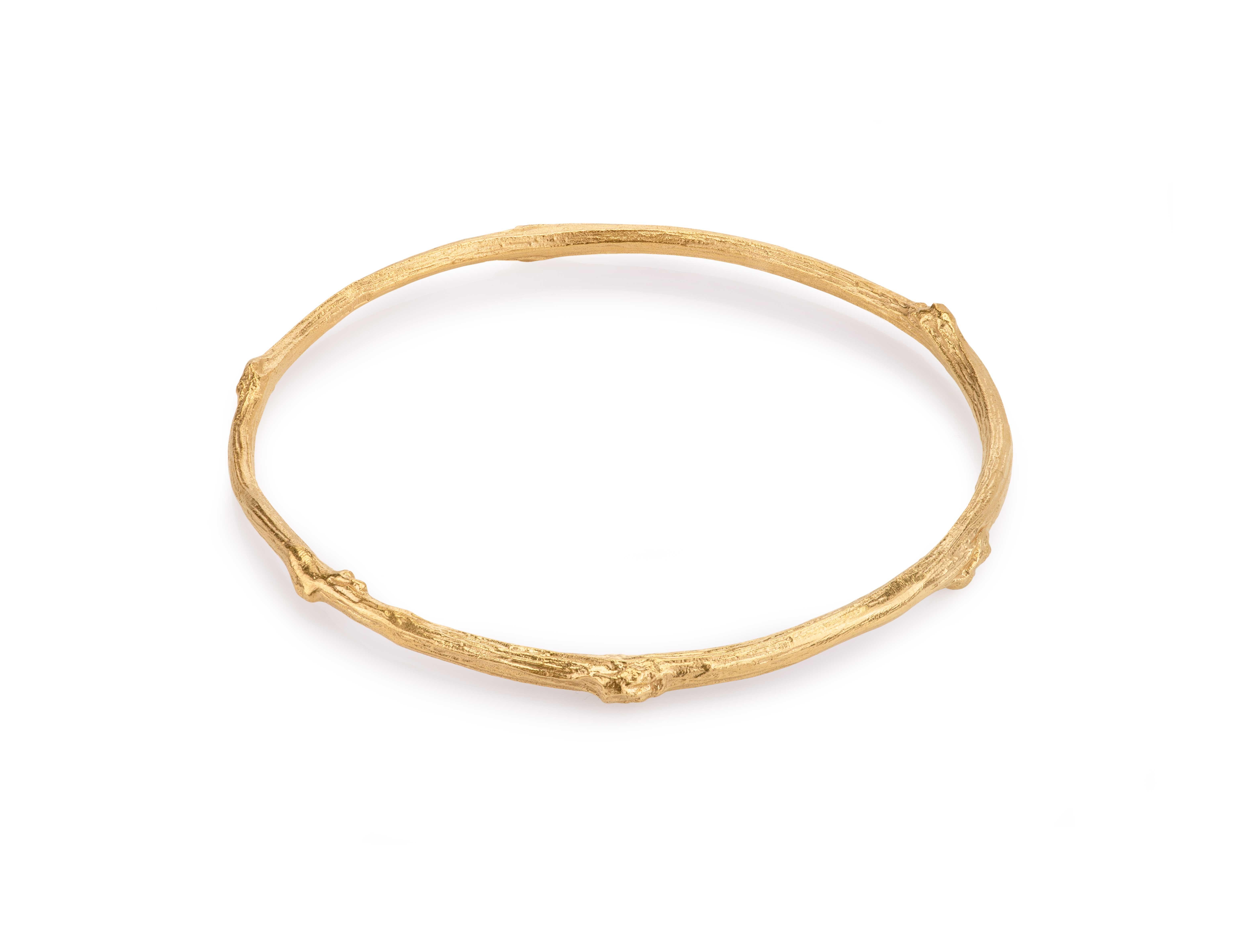 We made this beautiful solid 14 carat gold Rose twig bangle using a cast of a Rose twig we found in the Rose garden at Cockington Court, which is a stately home in Devon, England.

The rose twig bangle is a beautiful piece of solid piece of gold, it