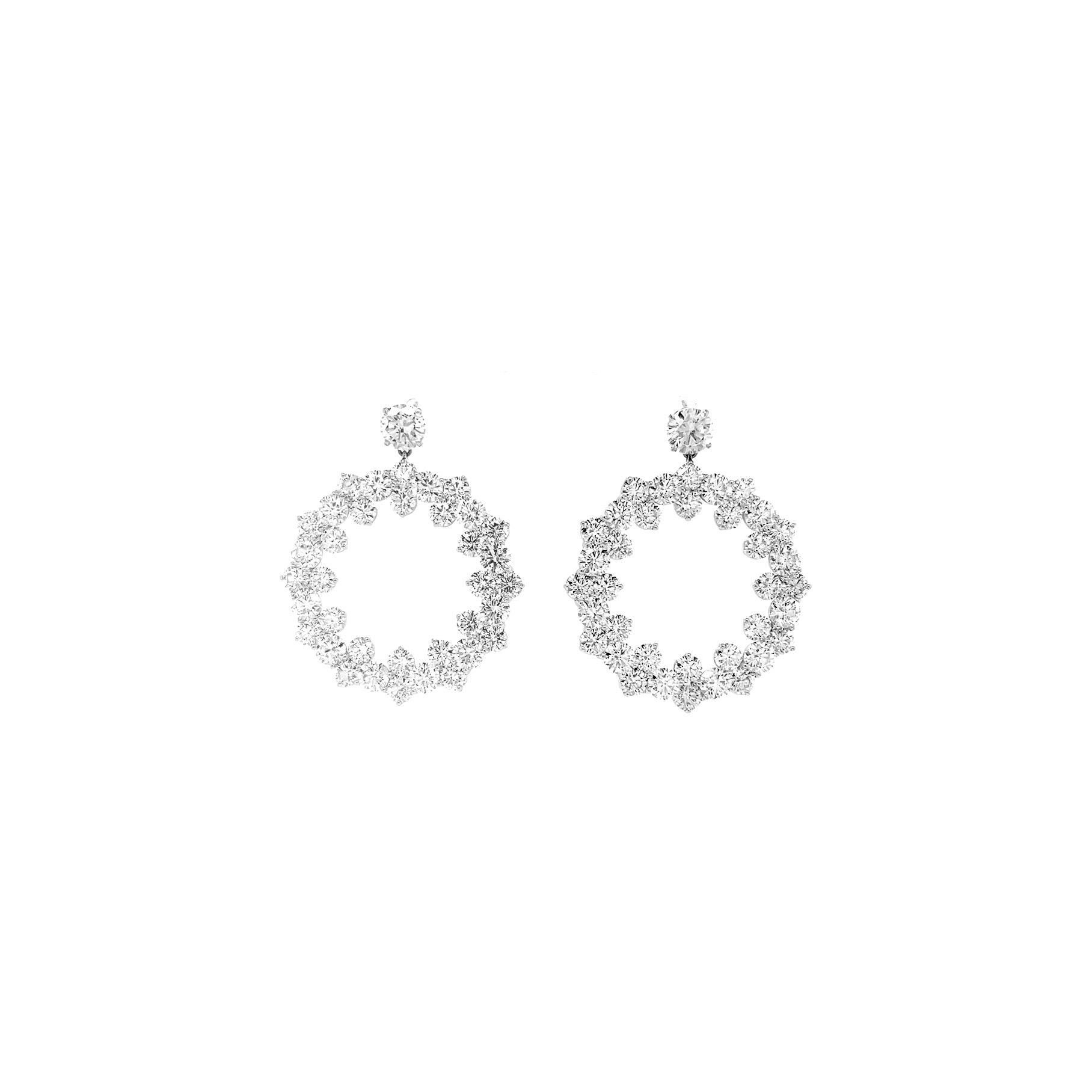 Introducing a breathtaking matched pair of 18K White Gold and Diamond Circular Drop Earrings. These exquisite chandelier drop earrings feature 74 round brilliant -shaped emerald stones totaling 14 carats G color, VS2 clarity. Set in polished 18k