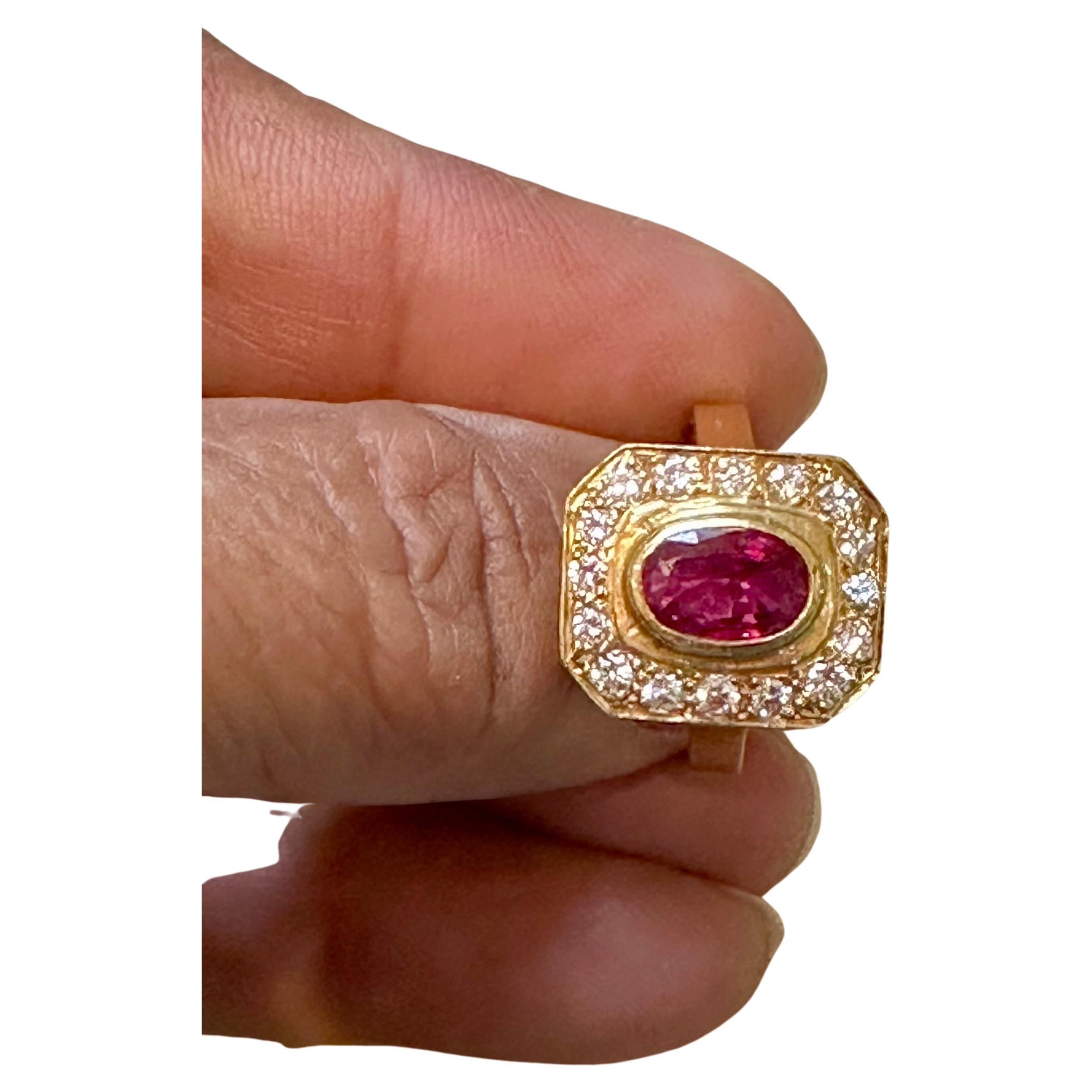 Introducing our exquisite 18 Karat Gold Ring, featuring a stunning 1.4 carat natural oval Ruby and approximately 0.80 carats of round brilliant cut diamonds. This ring is a true testament to beauty and elegance.

The natural Ruby in this ring is of