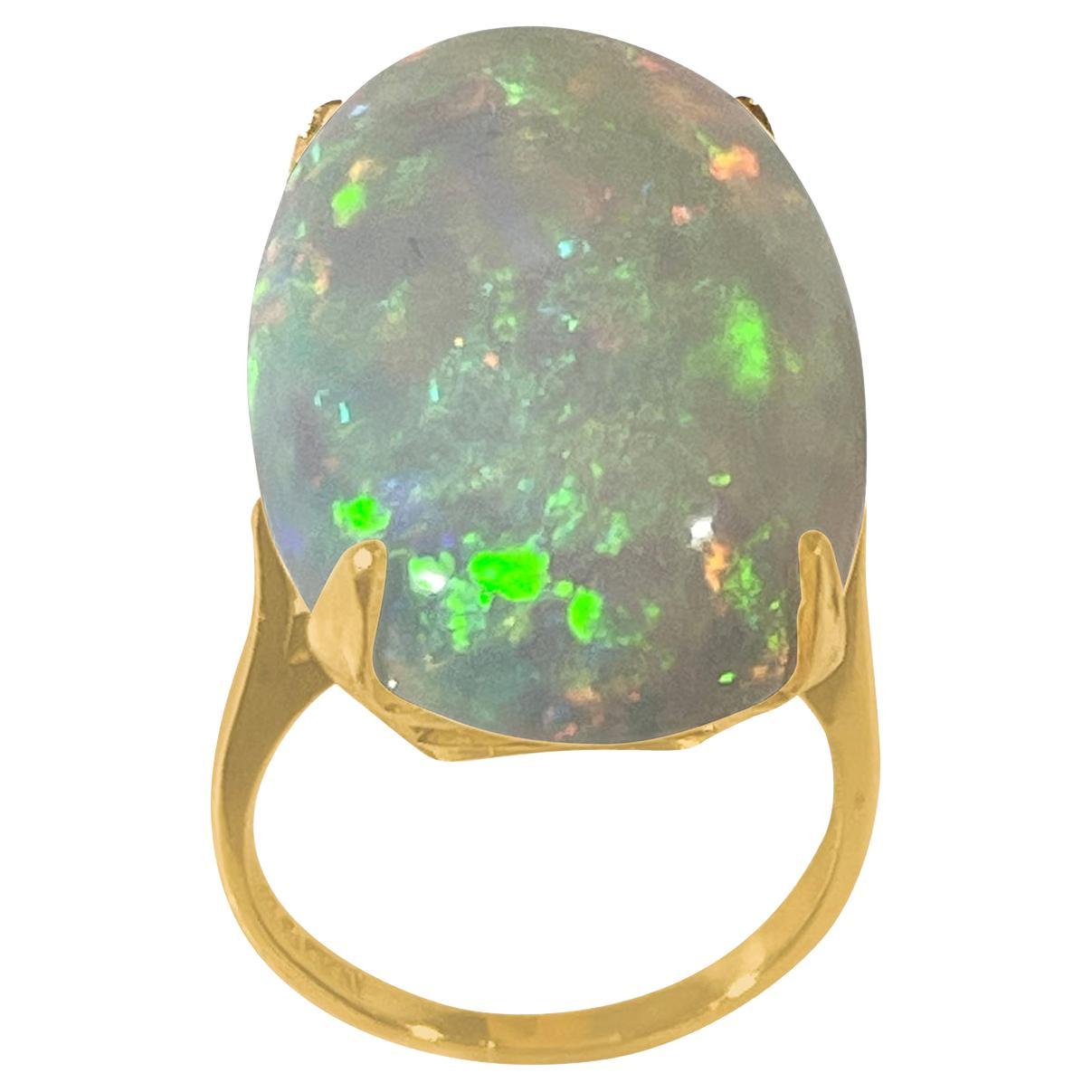 approximately 14 Carat Oval Shape Ethiopian Opal Cocktail Ring 14 Karat Yellow Gold  Ring size 5.5
Oval  Natural Opal  A classic, Cocktail ring 
14 Karat Yellow Gold Estate
Size of the opal 17 X 26 MM, Approximately 14 Ct
Amazing colors in this opal