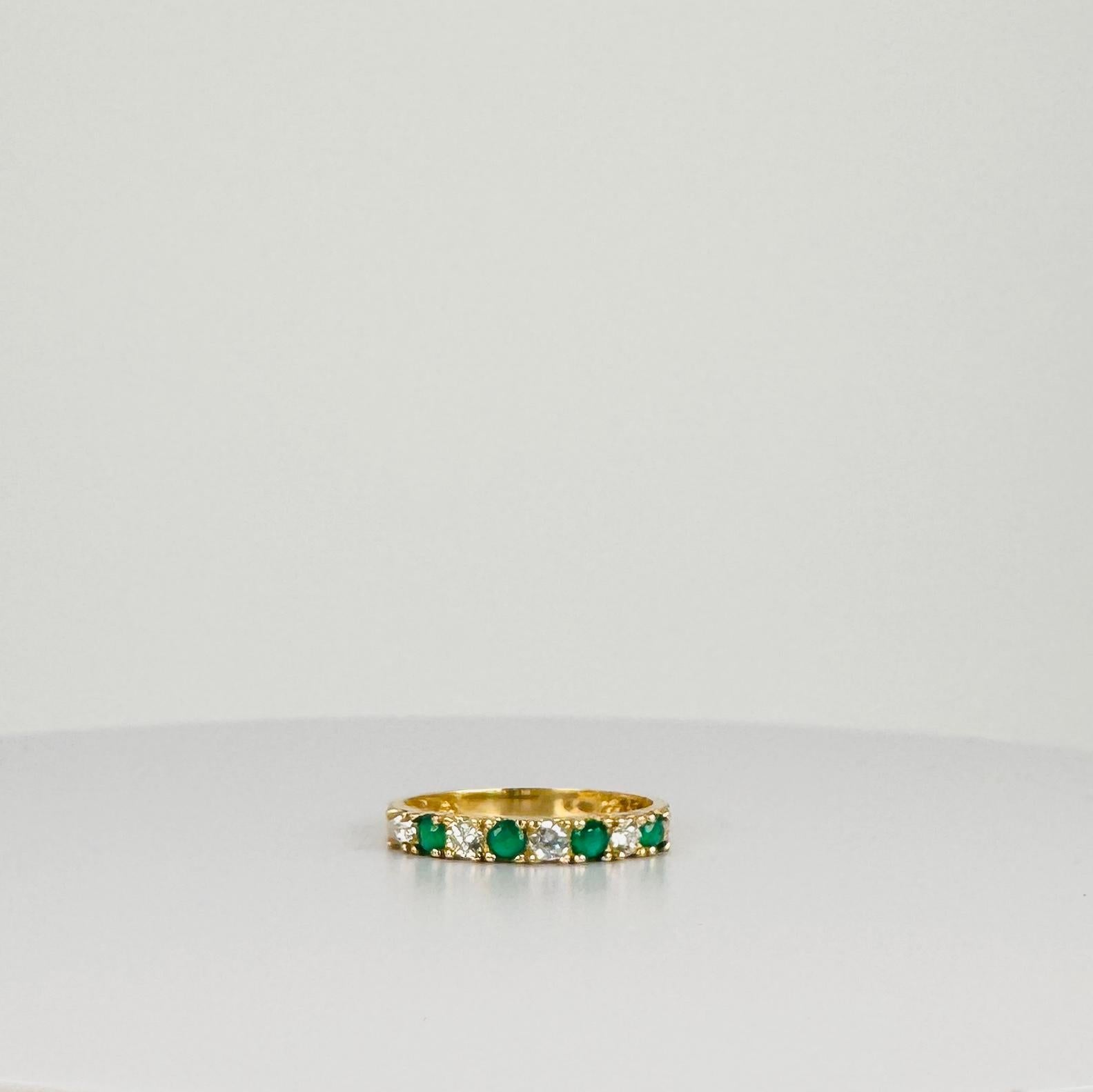 A playful mix of sparkle and colour. This vintage ring is set with alternating white sapphires and emeralds - a timeless classic with a subtle hint of green. Beautiful to stack, and also perfect to wear alone. 
      
Features: 
Material: 14 carat