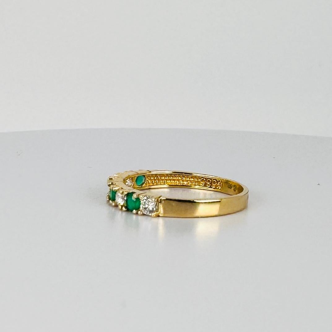 14 carat yellow gold bang ring with white sapphires and emerald 0.16 carat For Sale 1