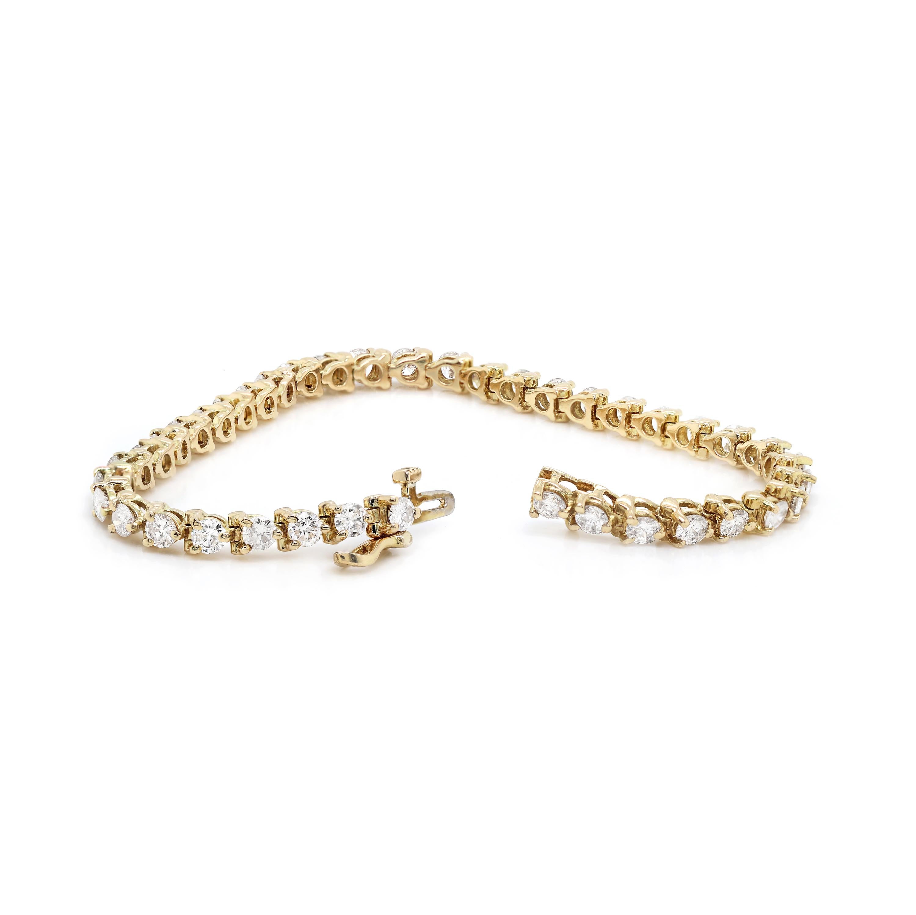 Beautiful tennis bracelet featuring 40 round brilliant cut diamonds mounted in three claw, open back settings. The diamonds weight an approximate total weight of 5.00ct, all mounted in 14 carat yellow gold. This timelessly elegant bracelet measures