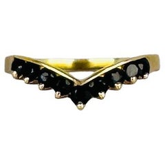 14 carat yellow gold ring with 9 round facetted blue sapphires 0.18 carat