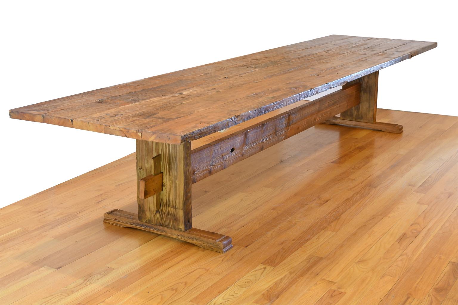 Inspired by an antique Swedish table from the early 1800's once in our inventory, this beautiful 14-foot-long custom dining table is made from repurposed antique pine wood. The distressed top and base have been finished with tung oil varnish for a