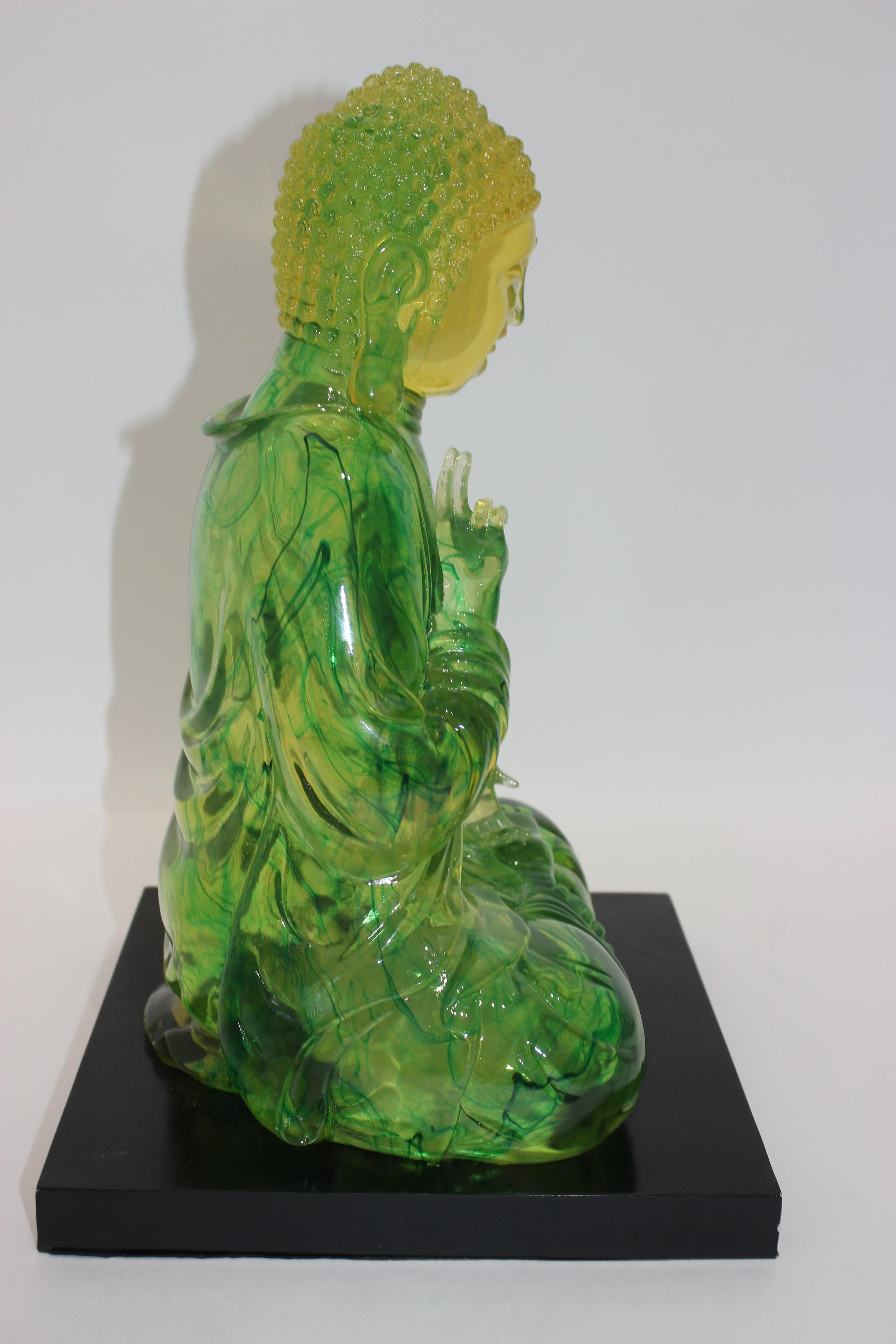 This is a beautiful vibrant green & yellow 14 inch tall Lucite seated Buddha on black base.

   
  