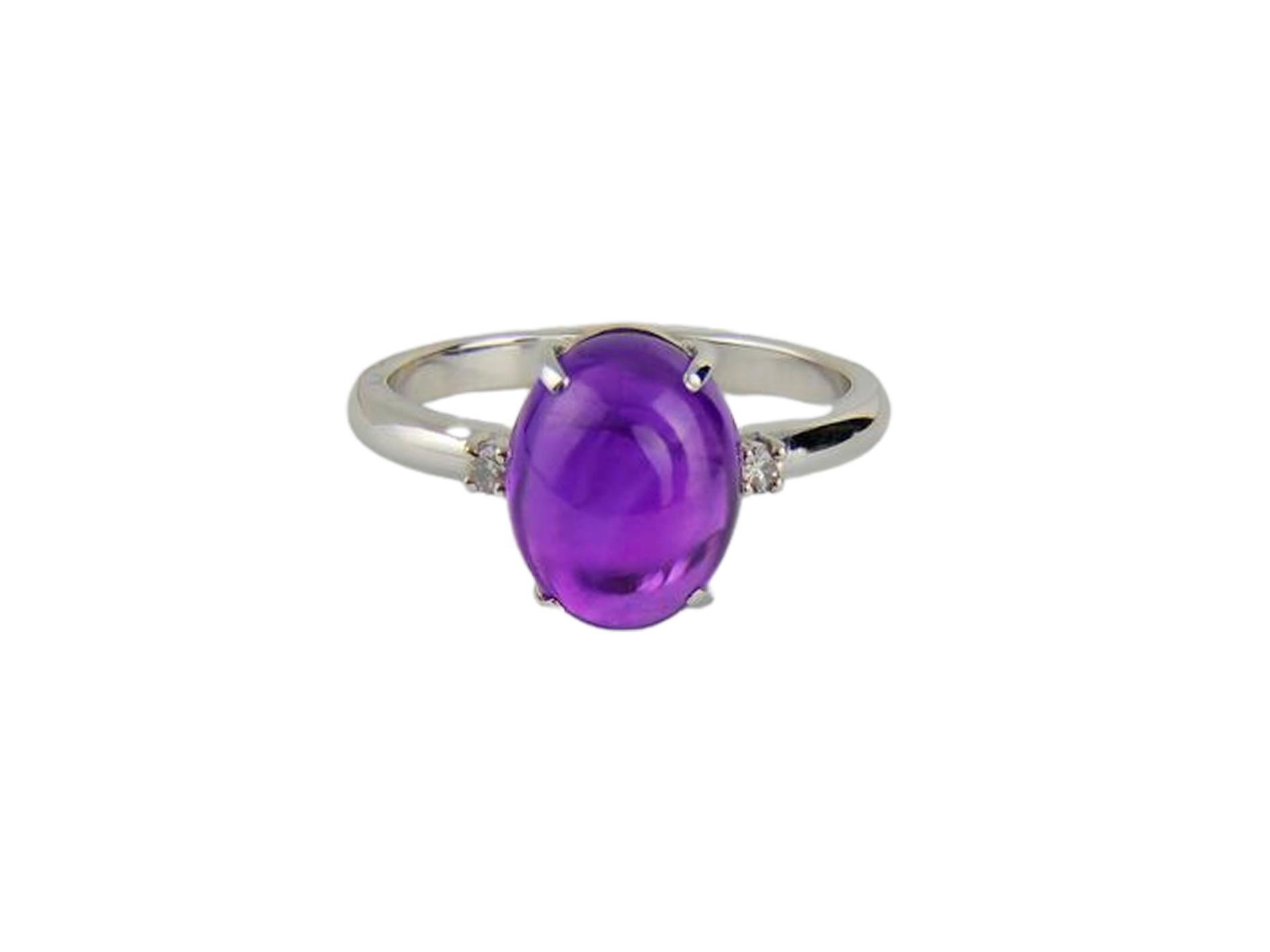 Minimalism style white gold ring with natural amethyst cabochon and diamonds. Are hand made item. 
Weight approx. 4.1 g 

Set with amethyst.
4.79 ct. oval cabochon cut amethyst. 
Colour: Purple
Clarity: Transparent

Surrounding stone - Diamonds