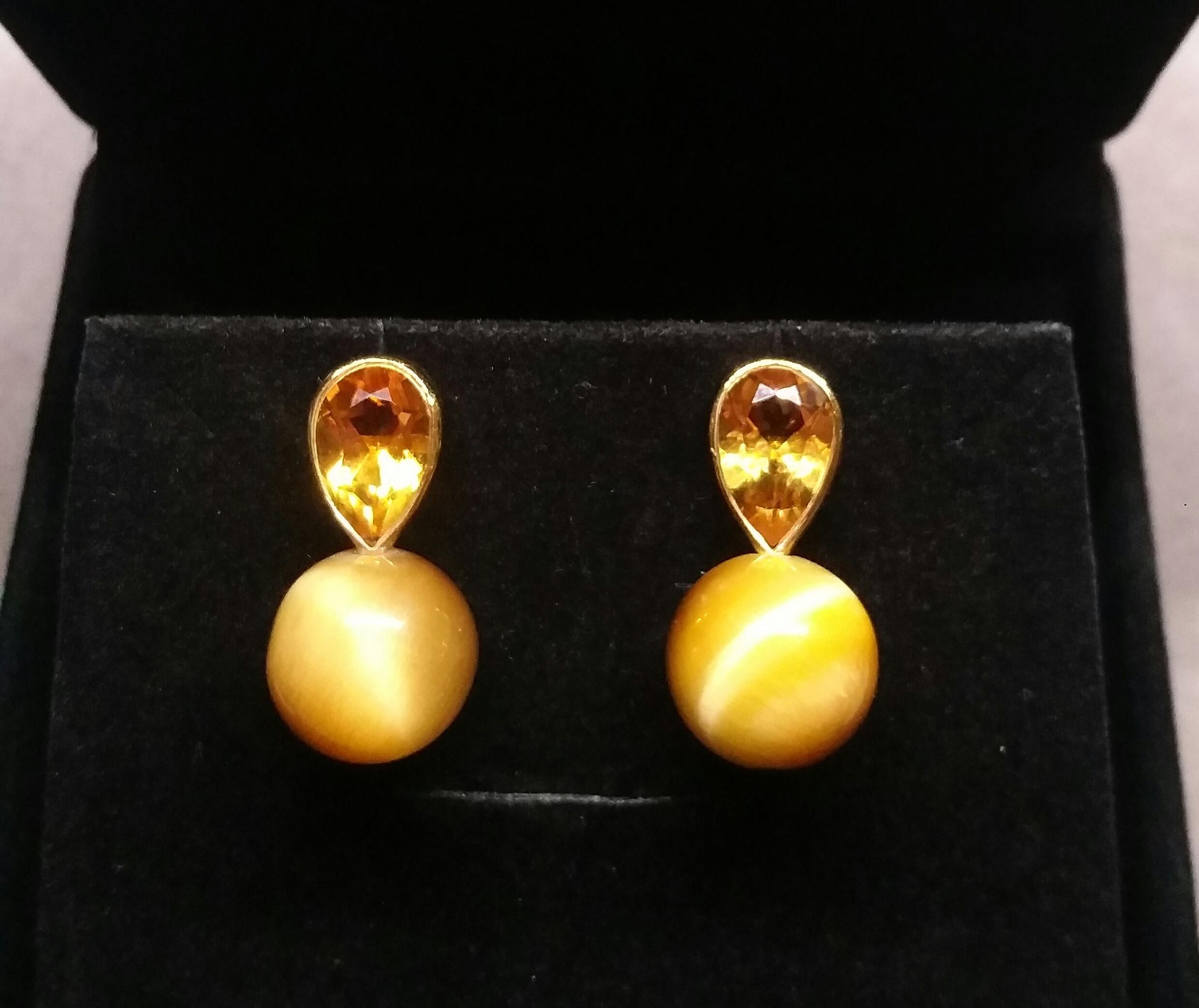 These simple but elegant and completely handmade earrings have 2 Pear Shape Faceted  Natural Citrines measuring 7 x 12 mm set in yellow gold bezel at the top to which are suspended 2  Golden Tiger Eye Round Beads of 14 mm in diameter

In 1978 our