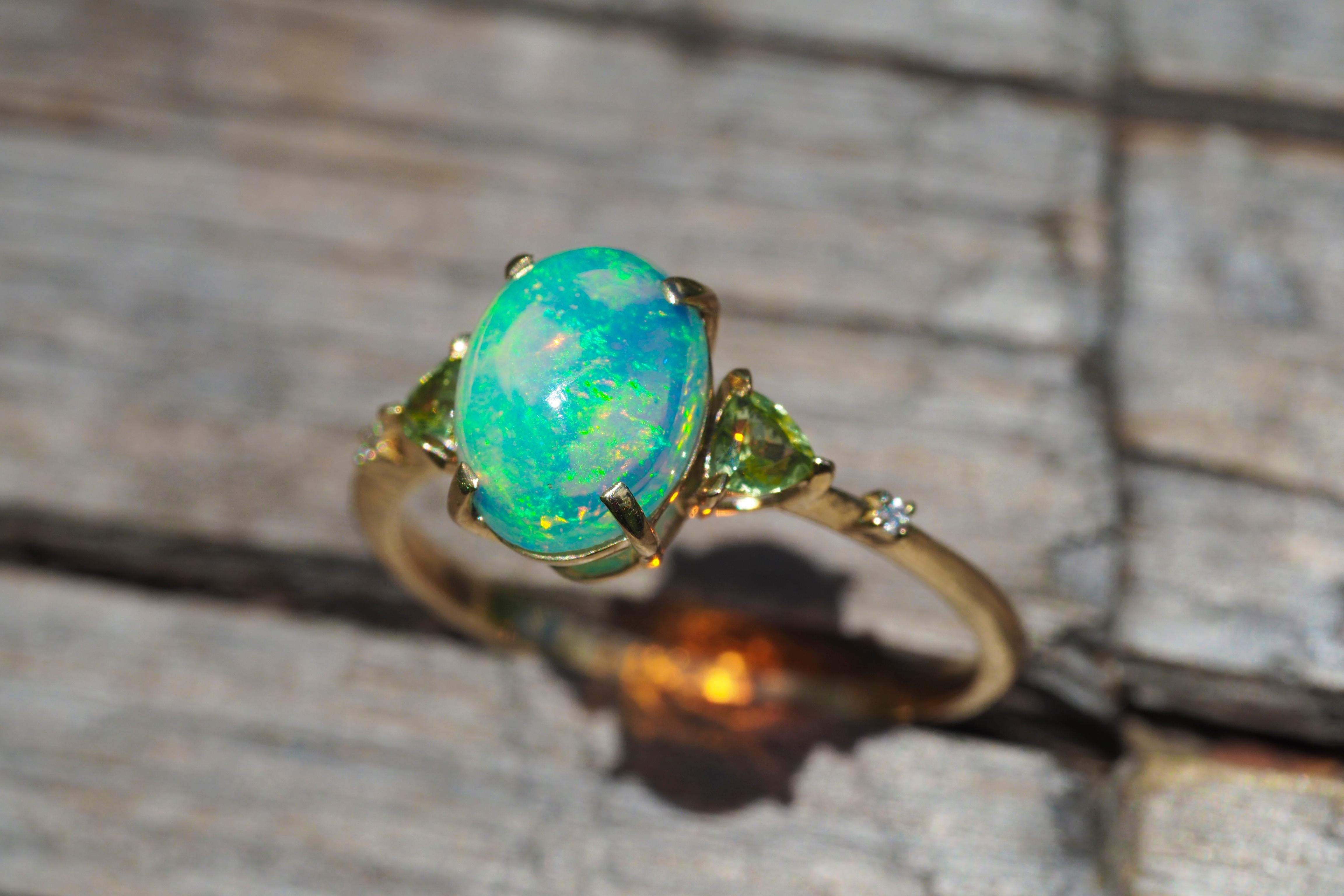 14 k gold ring with opal, peridot, diamonds. 
Dainty opal ring. Opal promise ring. Opal engagement ring. Oval opal ring. Opal vintage ring.

Metal: 14k gold
Weight: 2.0 g. depends from size

Central stone: Opal
Cut: Oval cabochon
Weight: approx 1.4