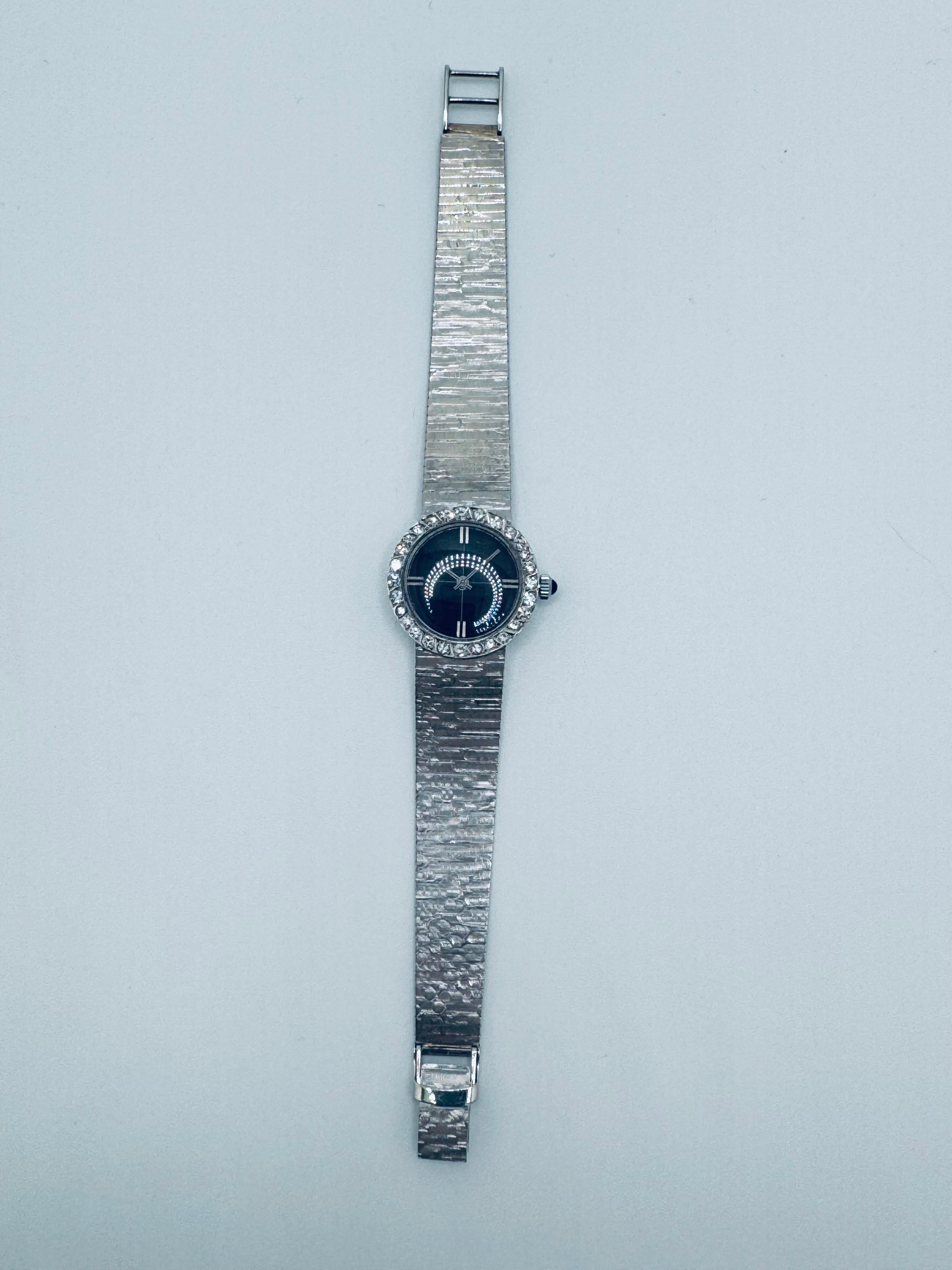 This elegant Longines women's watch, crafted in 14K white gold, dates back to circa 1955. The timepiece showcases a vintage charm with a total diamond weight of approximately 0.84 carats, featuring single-cut diamonds in a bezel setting. The dial is