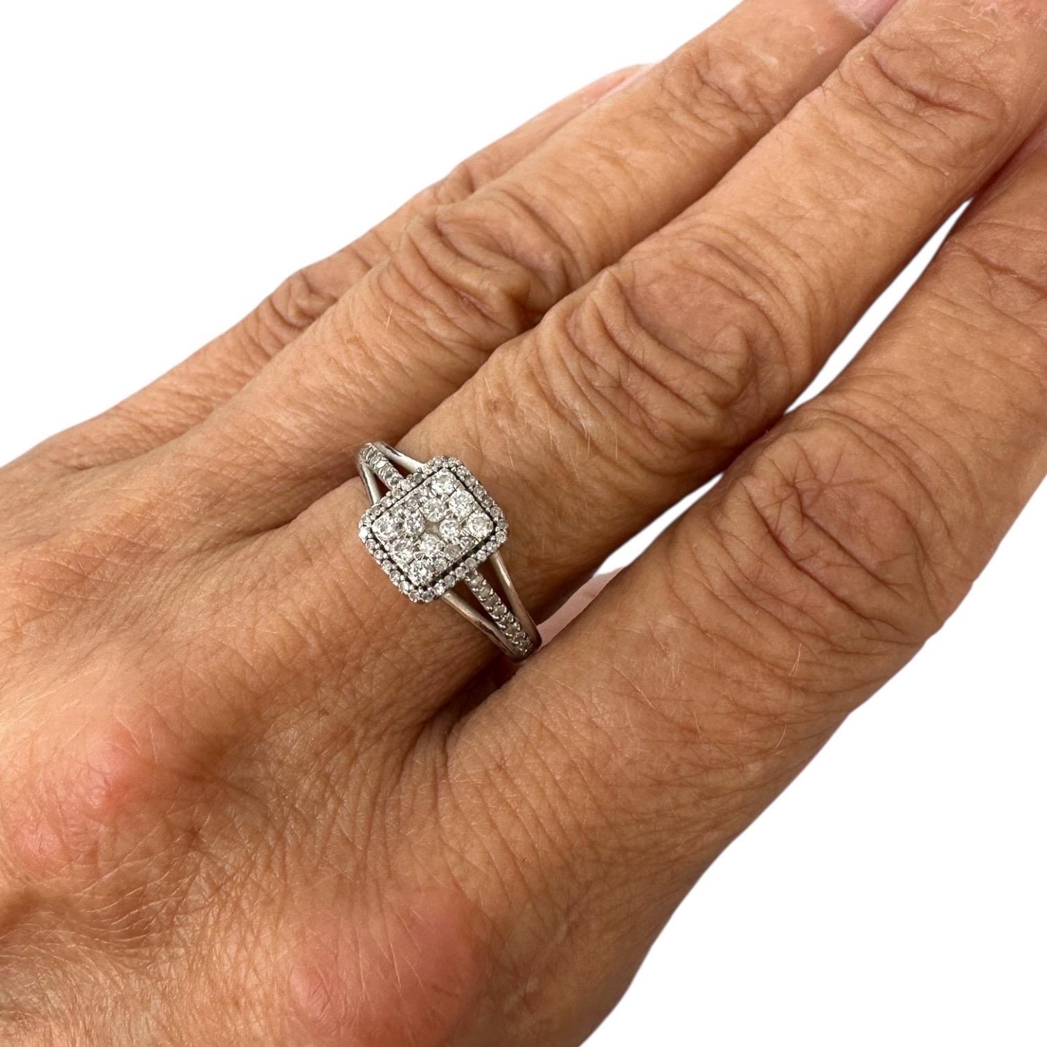 This 14kt white gold diamond ring boasts a striking rectangular shaped halo measuring 9.40 mm by 8.40 mm. Adorned with pave set diamonds of quality SI and color, this ring exudes elegance and sophistication. With a 1.00 carat diamond, it's the
