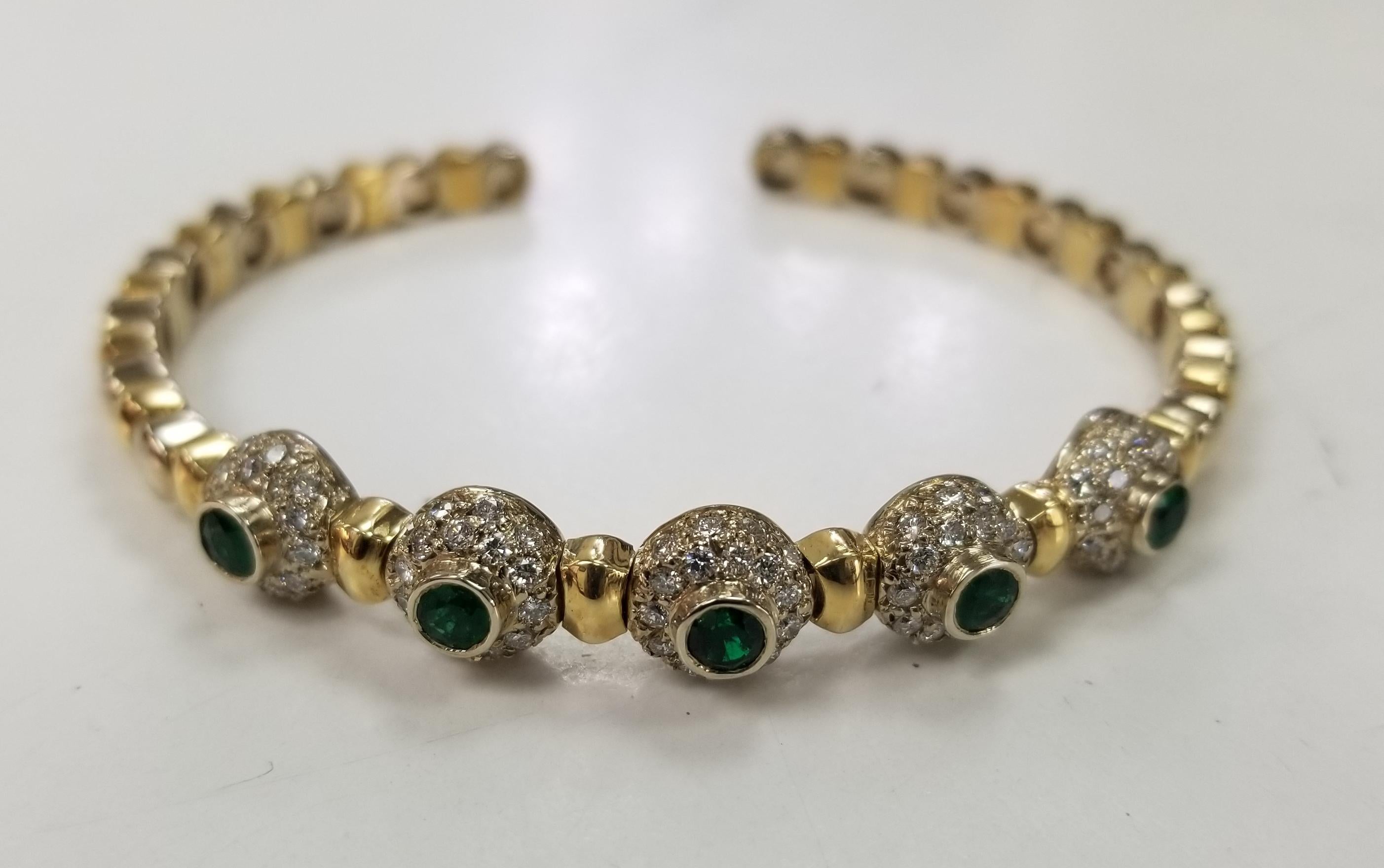 14 karat 2 tone gold Diamond and Emerald flexible bracelet, containing 95 round full cut diamonds; color 