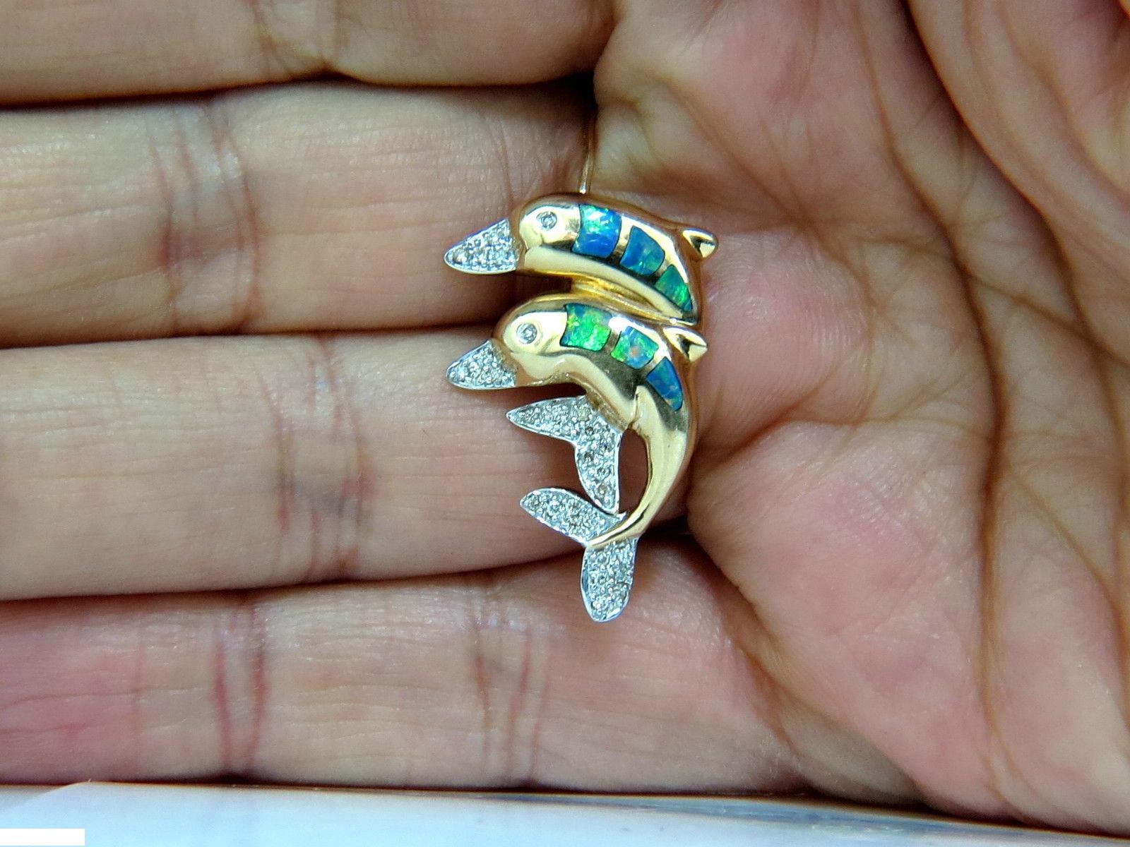 Gorgeous 3D real-life Dolphins pin

Diamonds: .20ct.

Round, H-color 

Vs-2 & Si-1 clarity

Natural Opals

Gorgeous threads of blues, reds and greens.

measurement of pin:

1.1 X .73 Inch.

4.1 grams

Marked 14Kt.

 $1800 Appraisal will accompany