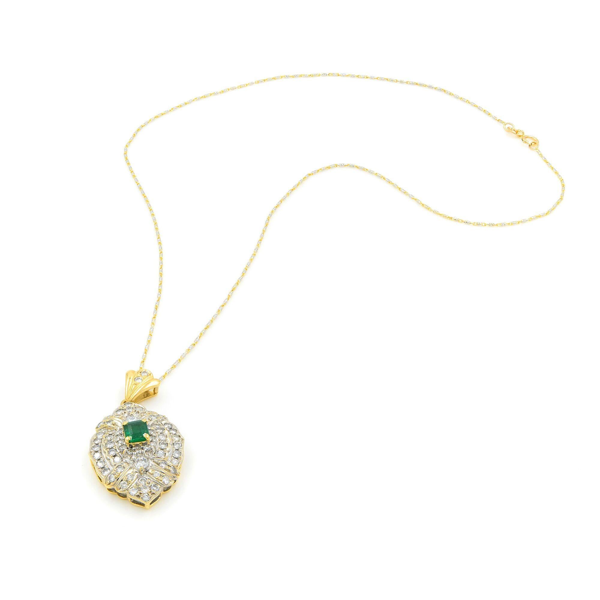 An extra bright, deep green emerald, weighing approx. 0.80ct and mounted on a yellow gold frame that's encrusted with diamonds. This pendant radiates from all the diamonds of this magnificent antique pendant, finely hand-crafted in two tone 18k