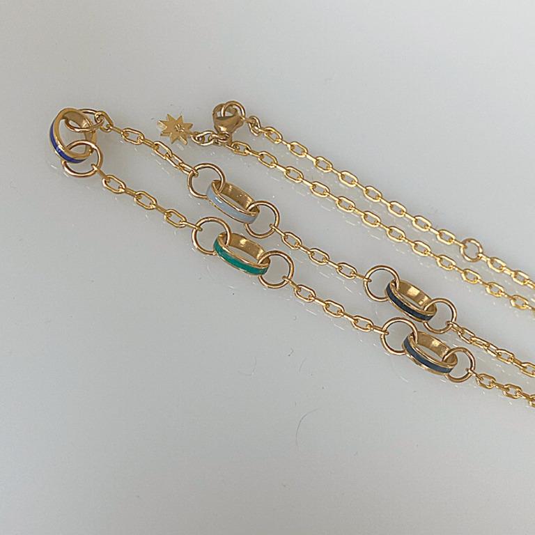 A whimsical, fashionable take on a classic chain link necklace.  The chain is interspersed with oval links, each with a stripe of different colored enamel.  The colors are rich hues, which add a pop to this necklace.  Perfect alone or layered with