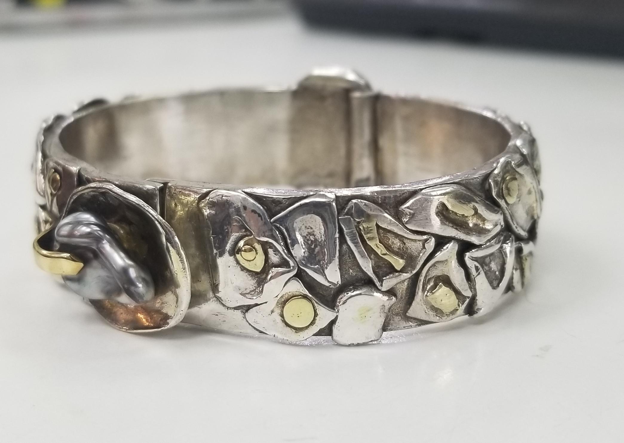 14 karat and silver Pearl bracelet, with a Tahitian pearl with in land 14k yellow gold pieces, bracelet weighs 89.66 grams. Very solid and sturdy.