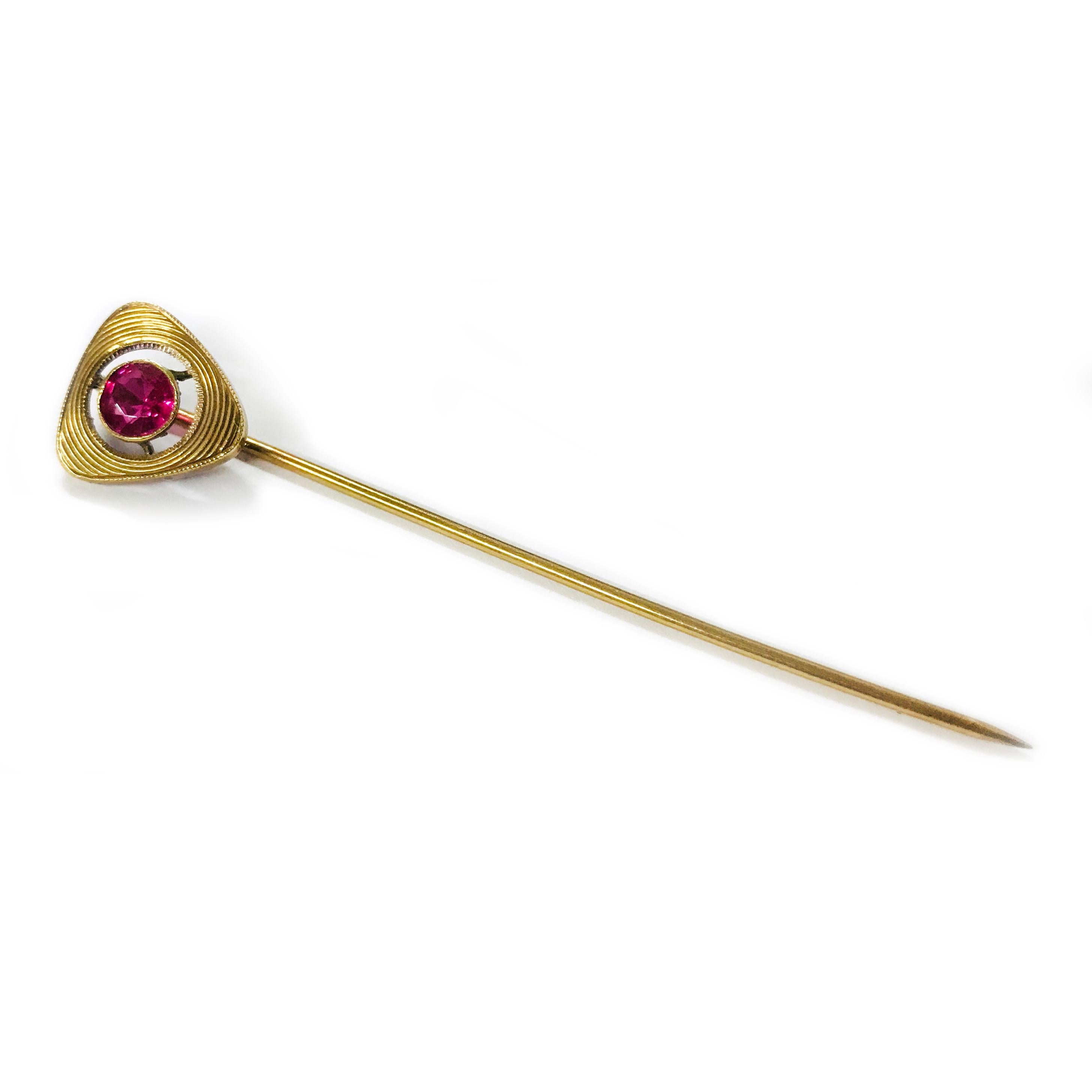 14 Karat Antique Ruby Hat Pin. A single round 5mm Ruby is bezel-set in the center of this triangle-shaped hat pin. The Ruby has a clean-eye with natural inclusions and has a total carat weight of 0.65ct. A simple yet elegant piece of antique