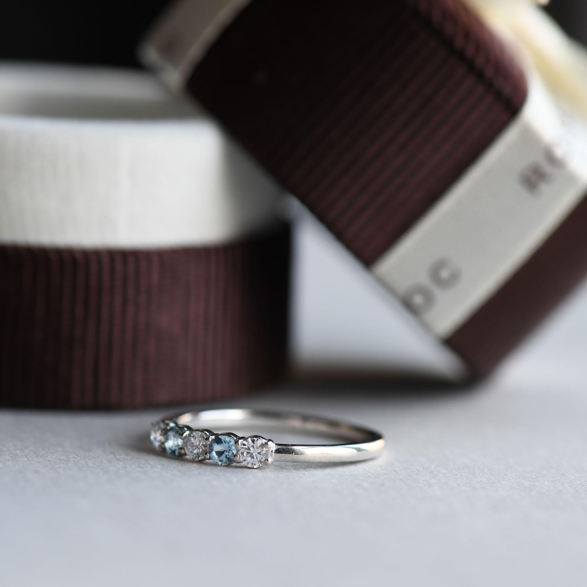 A row of five-stone with diamond and aquamarine set on 14k solid white gold.
Metal Type: 14 karat
Stone Size: 2.5mm stones
Diamond: .05ct per stone/3
Total diamond weight: 0.15ct
Clarity: VS
Color: GHI
Measurement: 1.3mm band width.

All of our