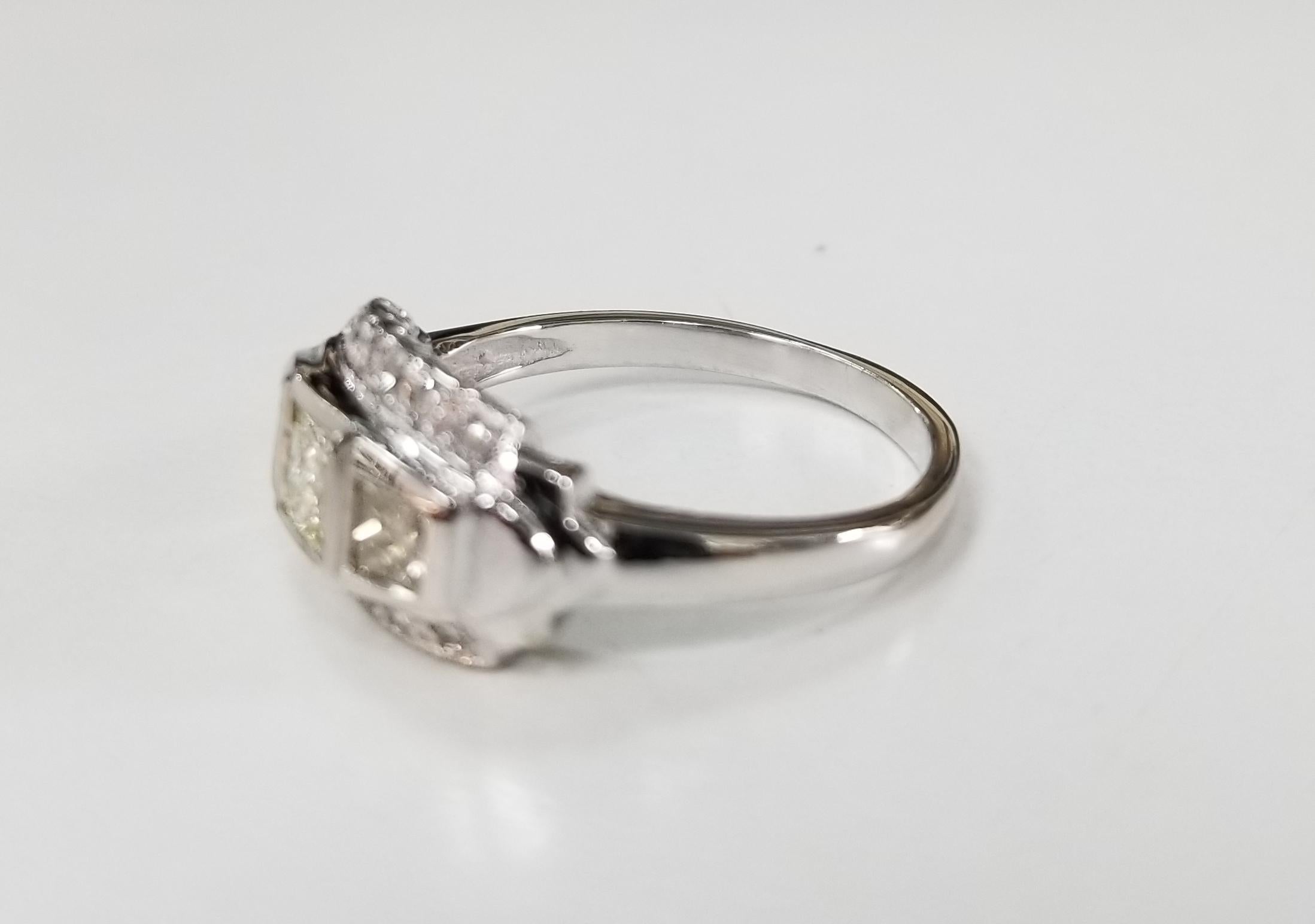 14 karat Art Deco Style diamond filigree ring, containing 3 princess cut diamonds of good quality weighing .56pts. and 12 round single cut diamonds weighing .15pts .ring is 6.25 and can be size to fit for free.