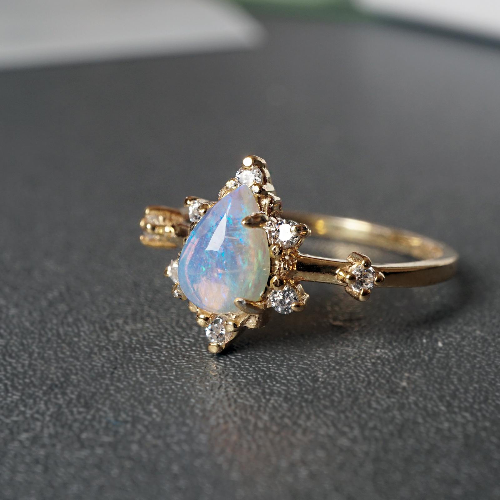 **This item is specially made for you. Please allow 1-2 week lead time. Make a note of your ring size and metal color during checkout.

This ring is a cosmic beauty for the ages. A beautiful Australian Opal glowing under the sunlight. Made in 14K