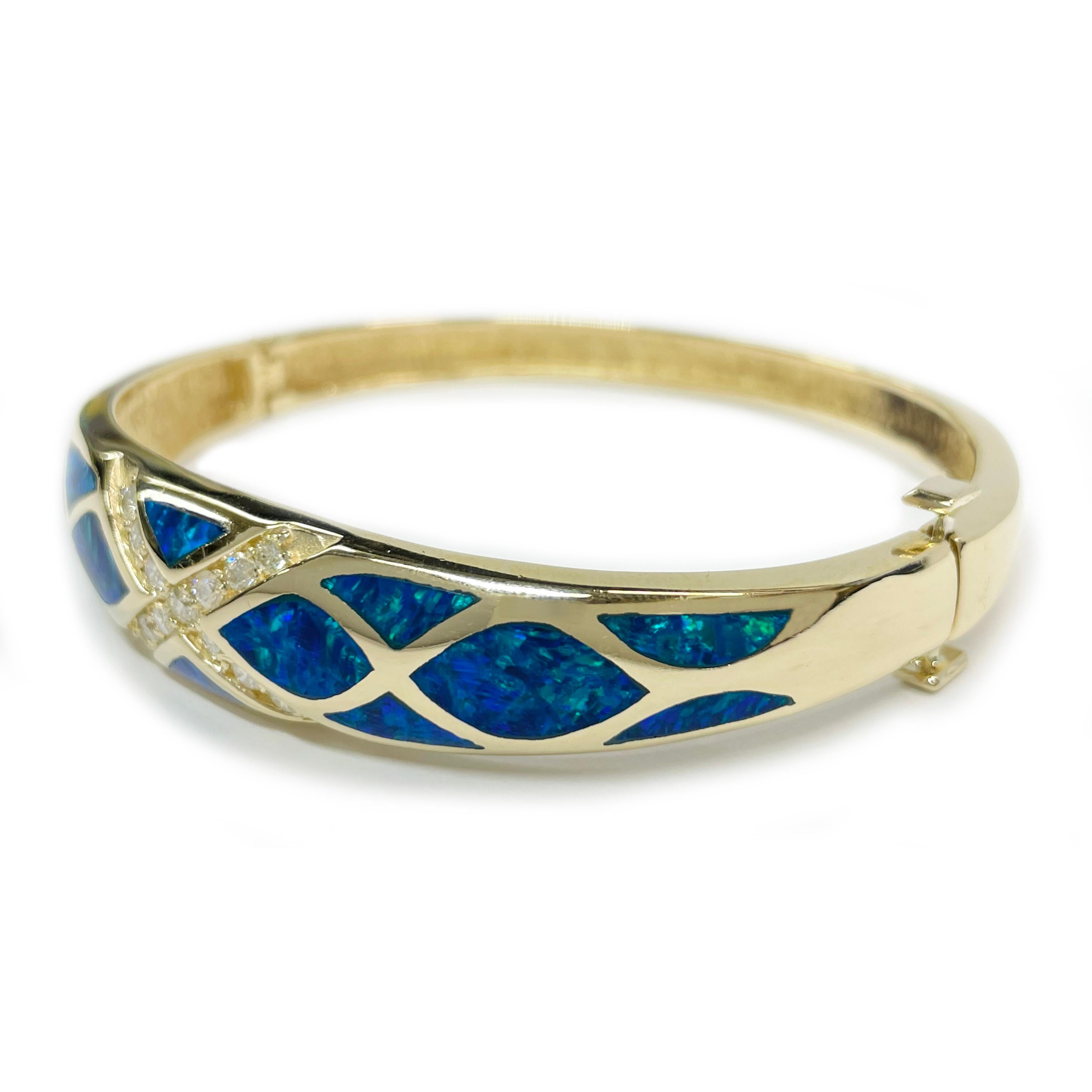 14 Karat Black Opal Bangle Hinged Bracelet. Absolutely striking bangle with diamonds set in a cross at the center and organic mermaid scale-like shaped inlays. The thirteen 2.5mm round prong-set diamonds have a carat total weight of 0.60ctw and are