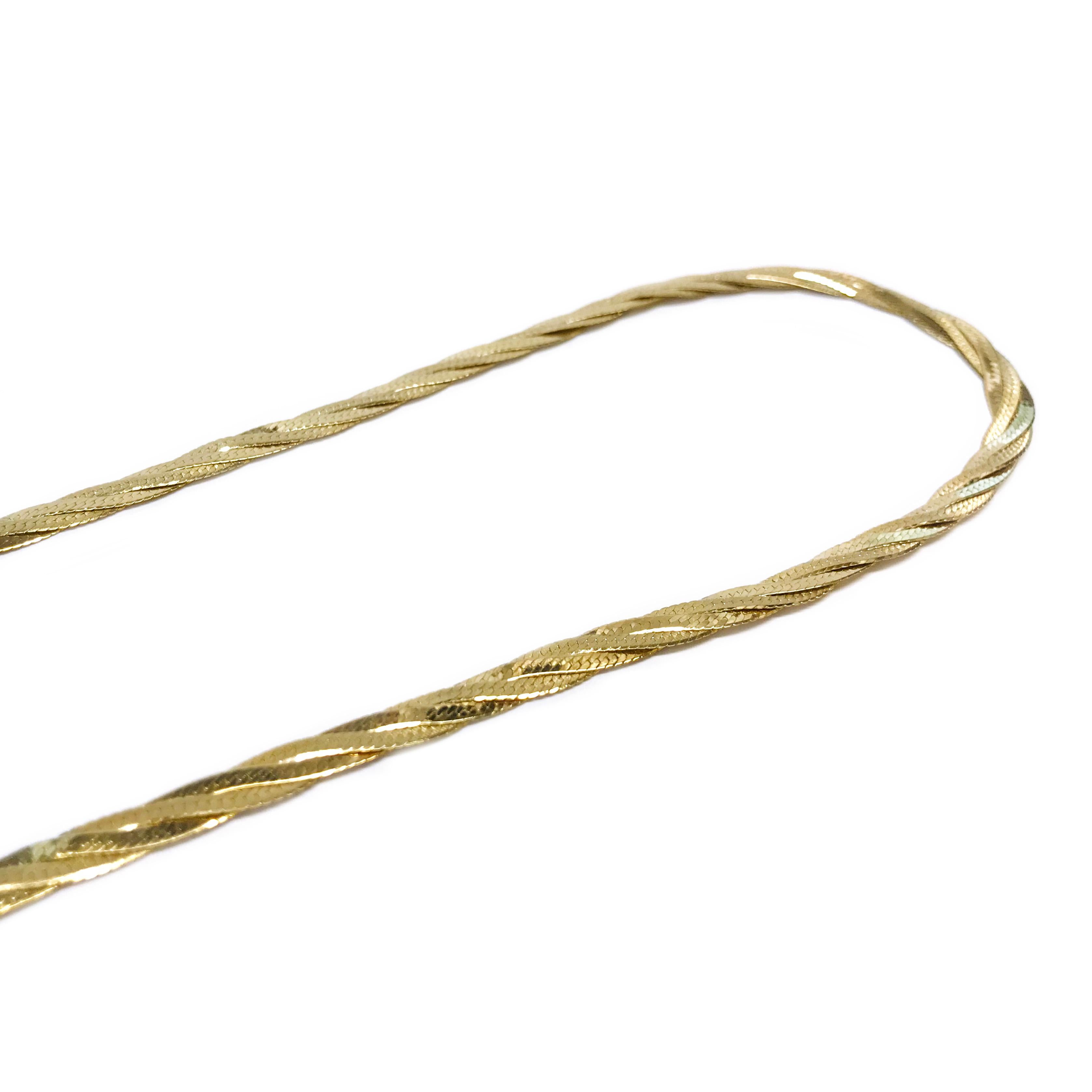 14 Karat Braided Herringbone Necklace. The herringbone necklaces are braided and create a shiny and matte visual on the front and back of the necklace. The necklace is 5mm wide and 16