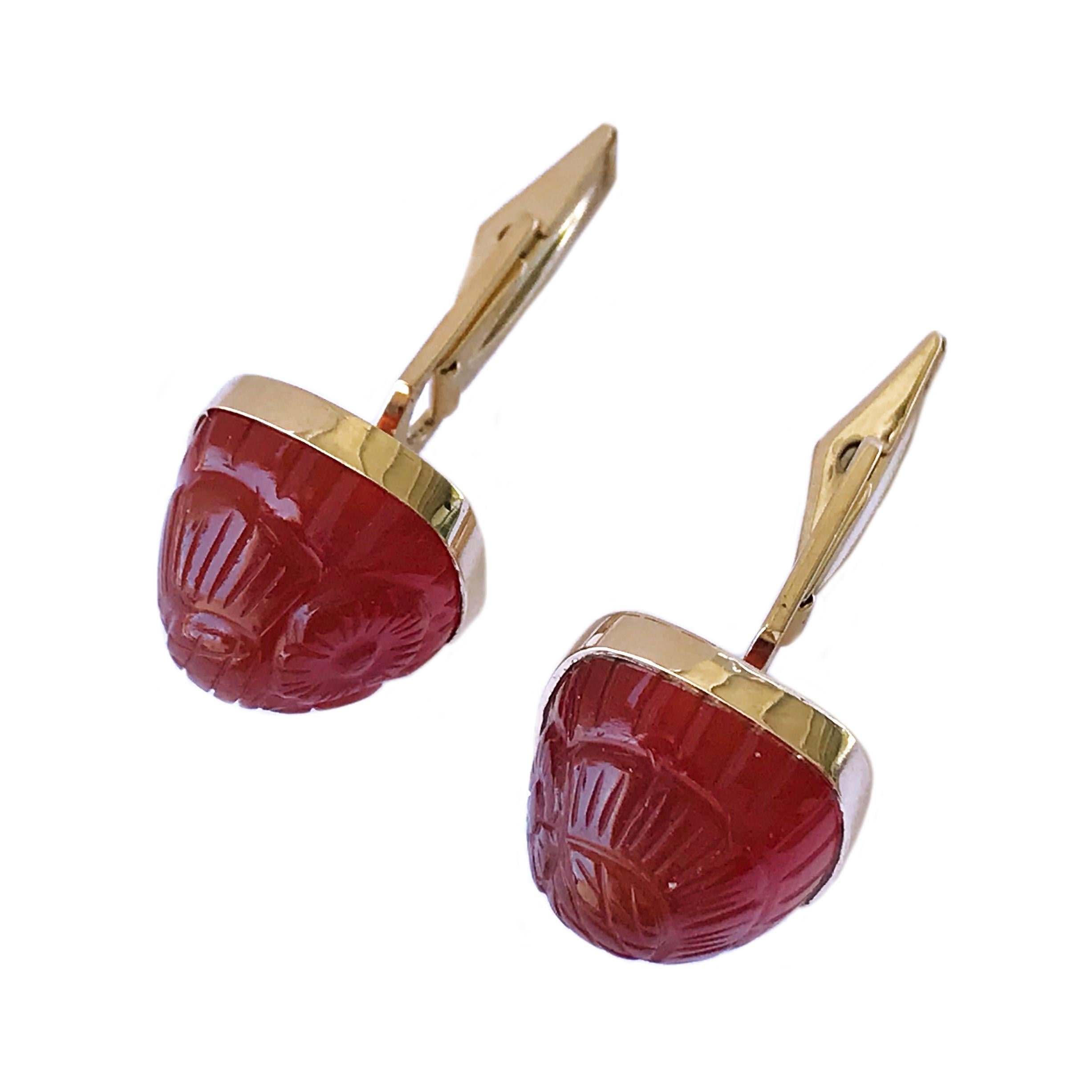 14 Karat Carved Carnelian Cufflinks. The front showcase carved Carnelian with a floral motif. The cufflinks have a smooth semi-smooth back, a dual post, and whale tail toggle backings. The cufflink measure approximately 15mm x 15mm. The cufflinks