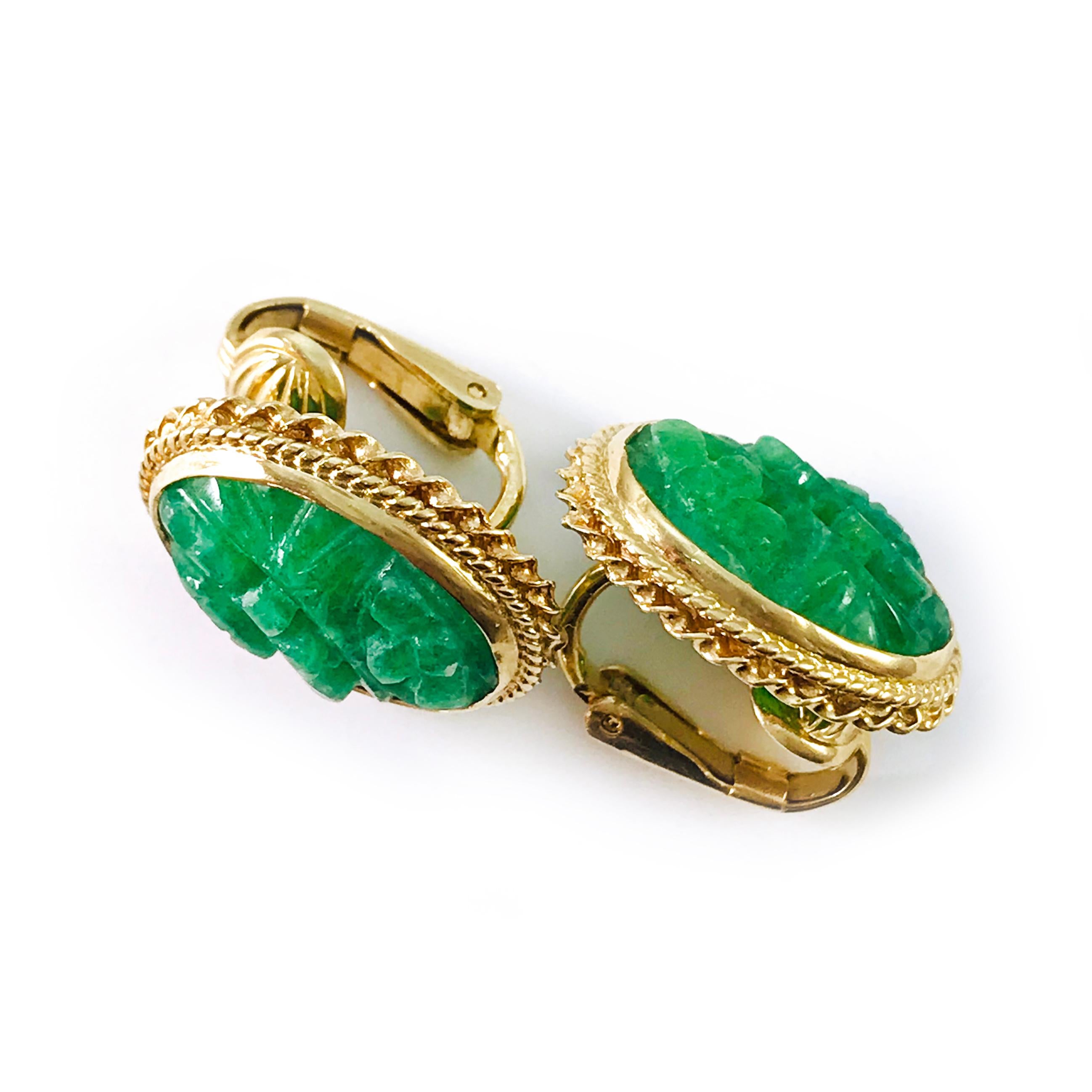 14 Karat Carved Green Jade Clip-On Earrings. Vibrant green carved Jade oval earrings with twisted gold rope detail wrapped around rope bezel, clip-on back. The weight of the earrings is 7.78 grams.
