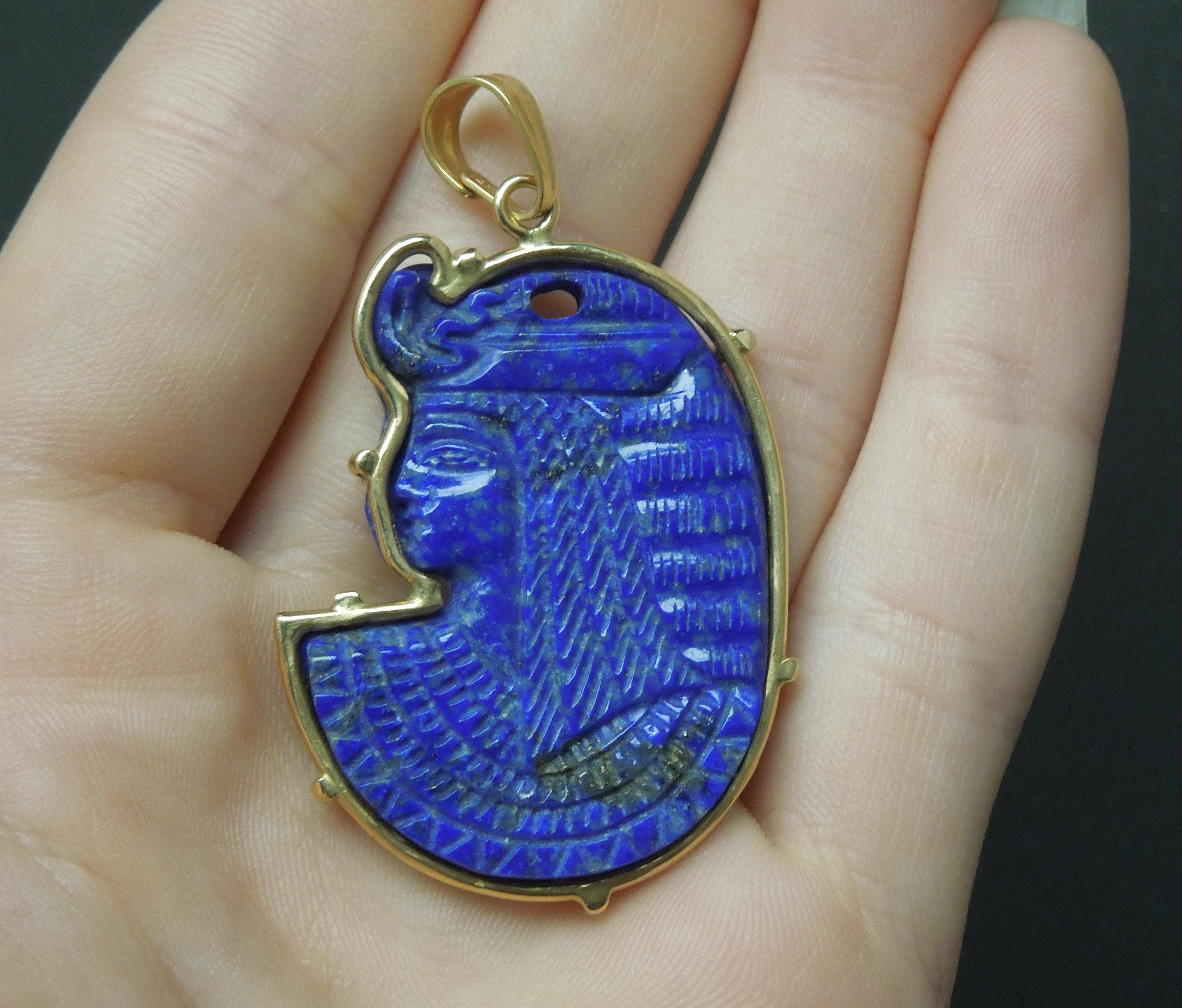 This Cleopatra Amulet Pendant features 1 Hand Carved piece of Natural Lapis Lazuli, secured in a Hand Fabricated 7-Prong frame setting. *Both Frame & Bale electronically tested for metal purity, constructed completely of 14 Karat Yellow Gold. The